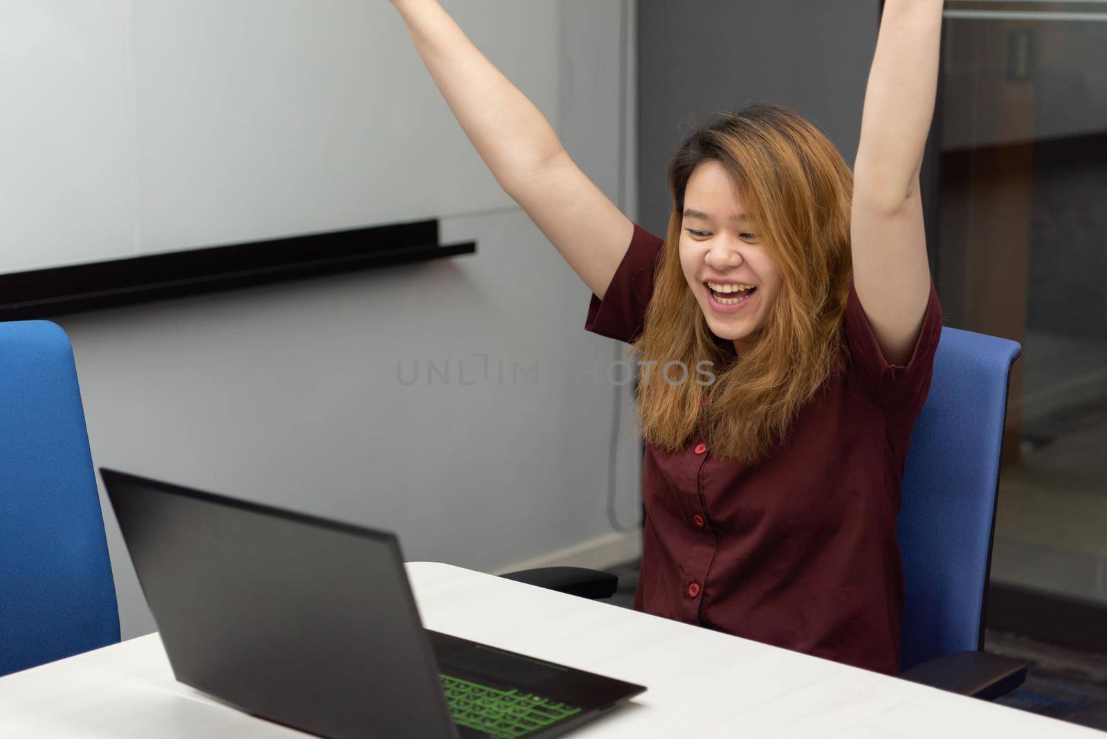 Woman working by laptop in office with happy by PongMoji