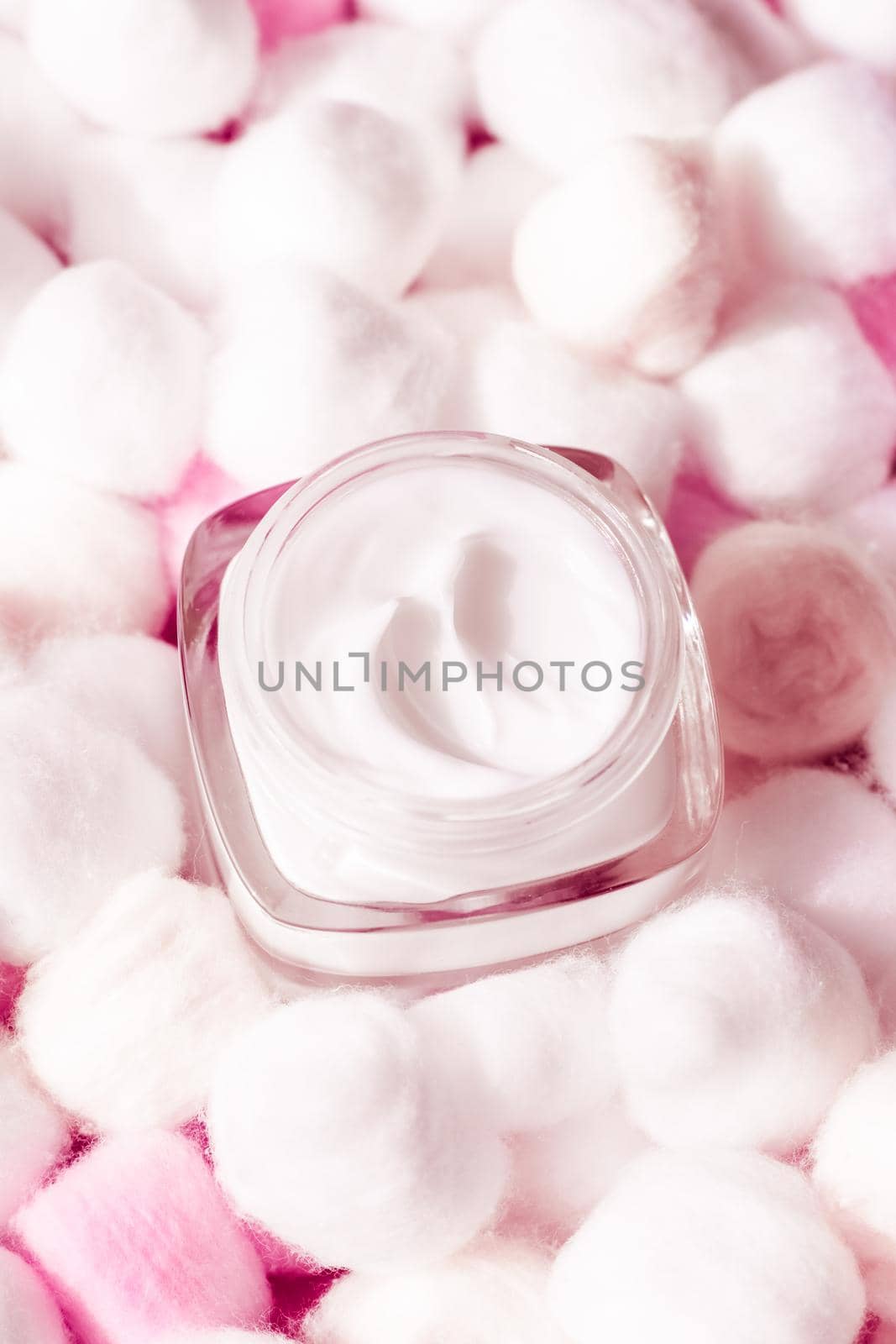 Cosmetic branding, moisturizing emulsion and facial care concept - Luxury face cream for sensitive skin and pink cotton balls on background, spa cosmetics and natural skincare beauty brand product