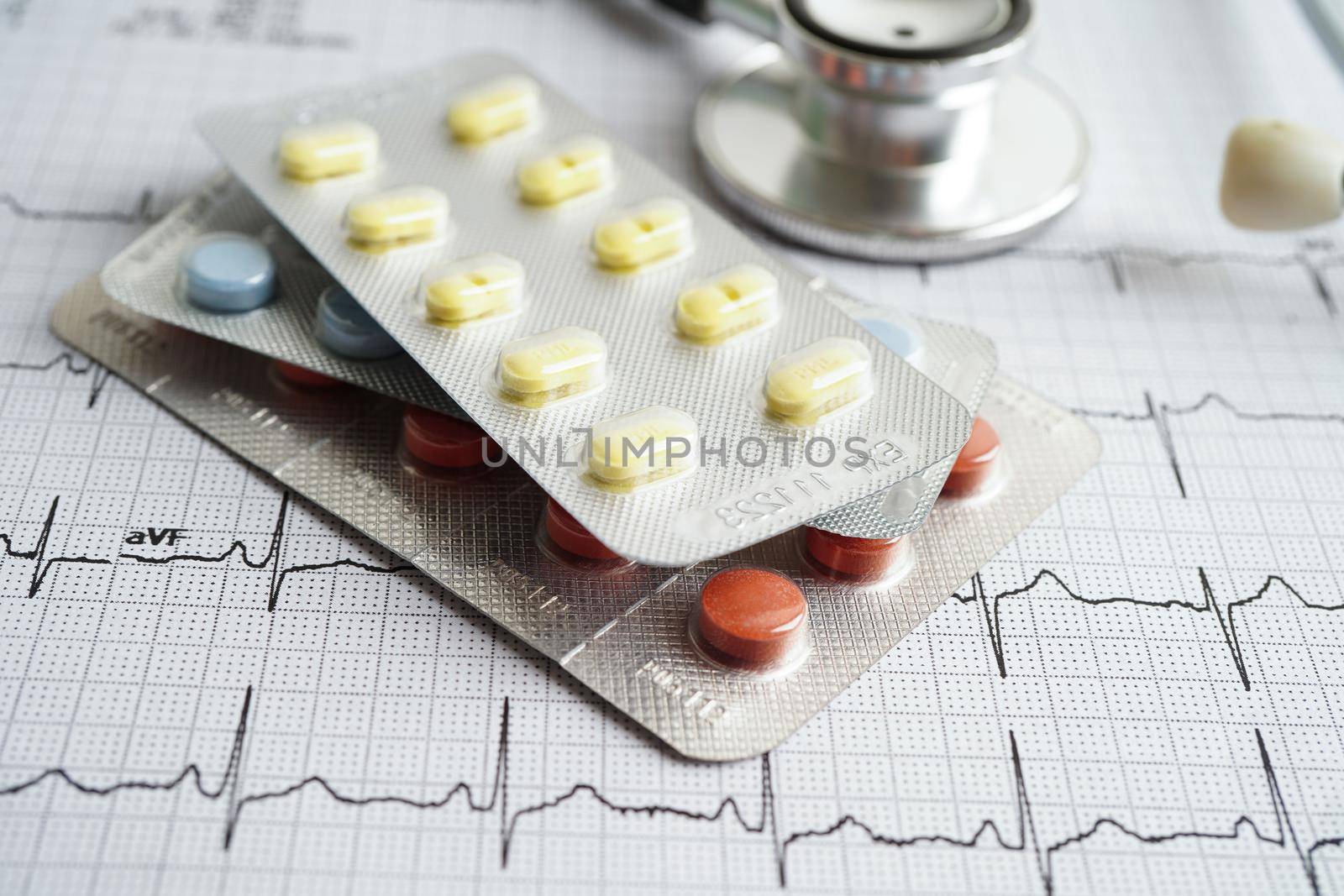 Stethoscope on electrocardiogram (ECG) with drug, heart wave, heart attack, cardiogram report.