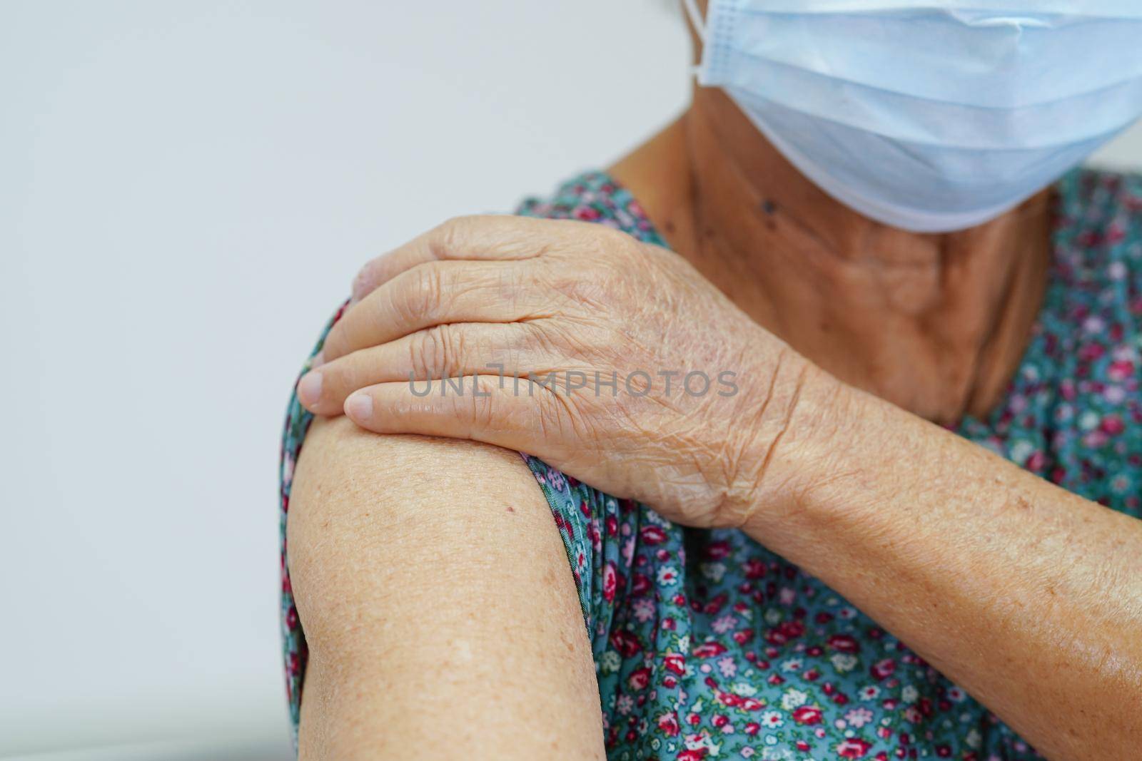 Asian elder senior woman patient wearing a protective mask for protect pollution environment and covid-19 coronavirus.