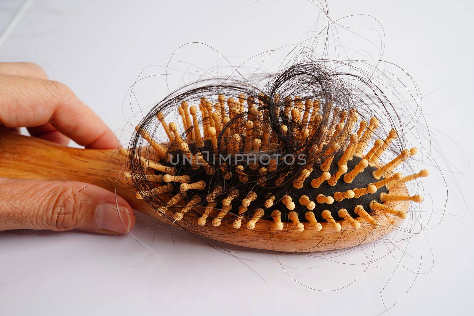 Hair loss fall with comb brush isolated on white background.