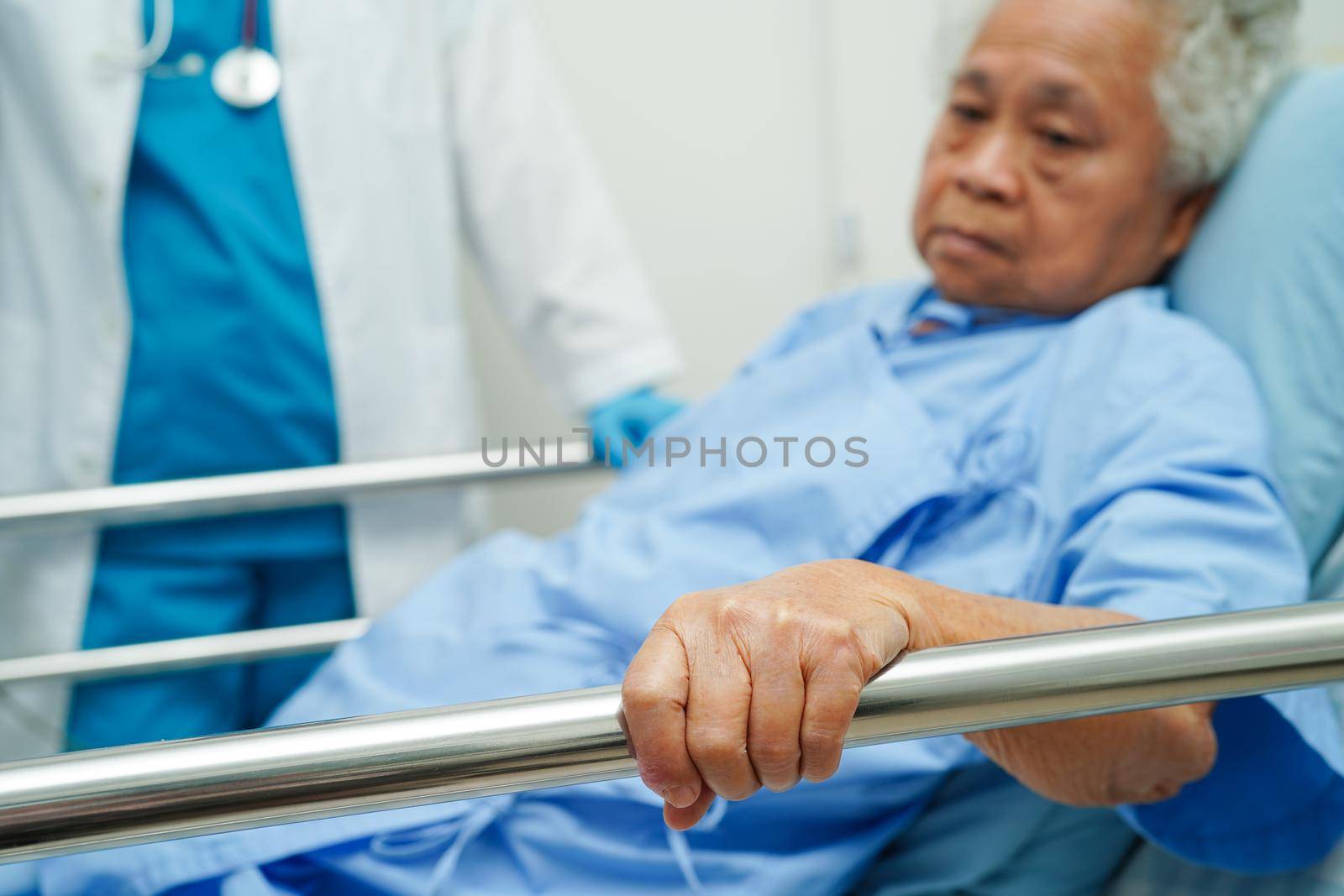 Asia doctor with stethoscope checking elderly woman patient in hospital, healthy medical concept.