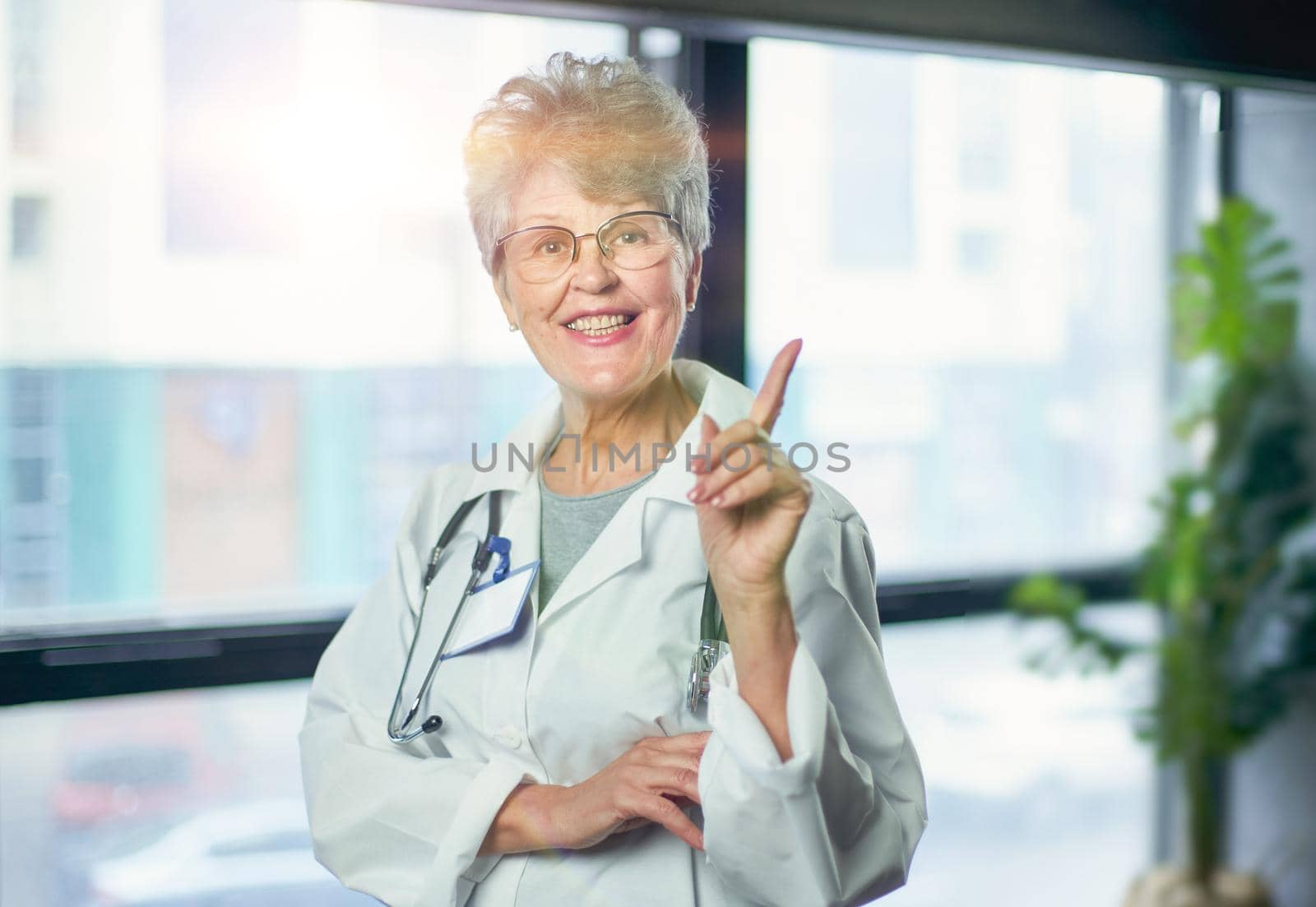 Friendly mature female doctor at hospital smiling