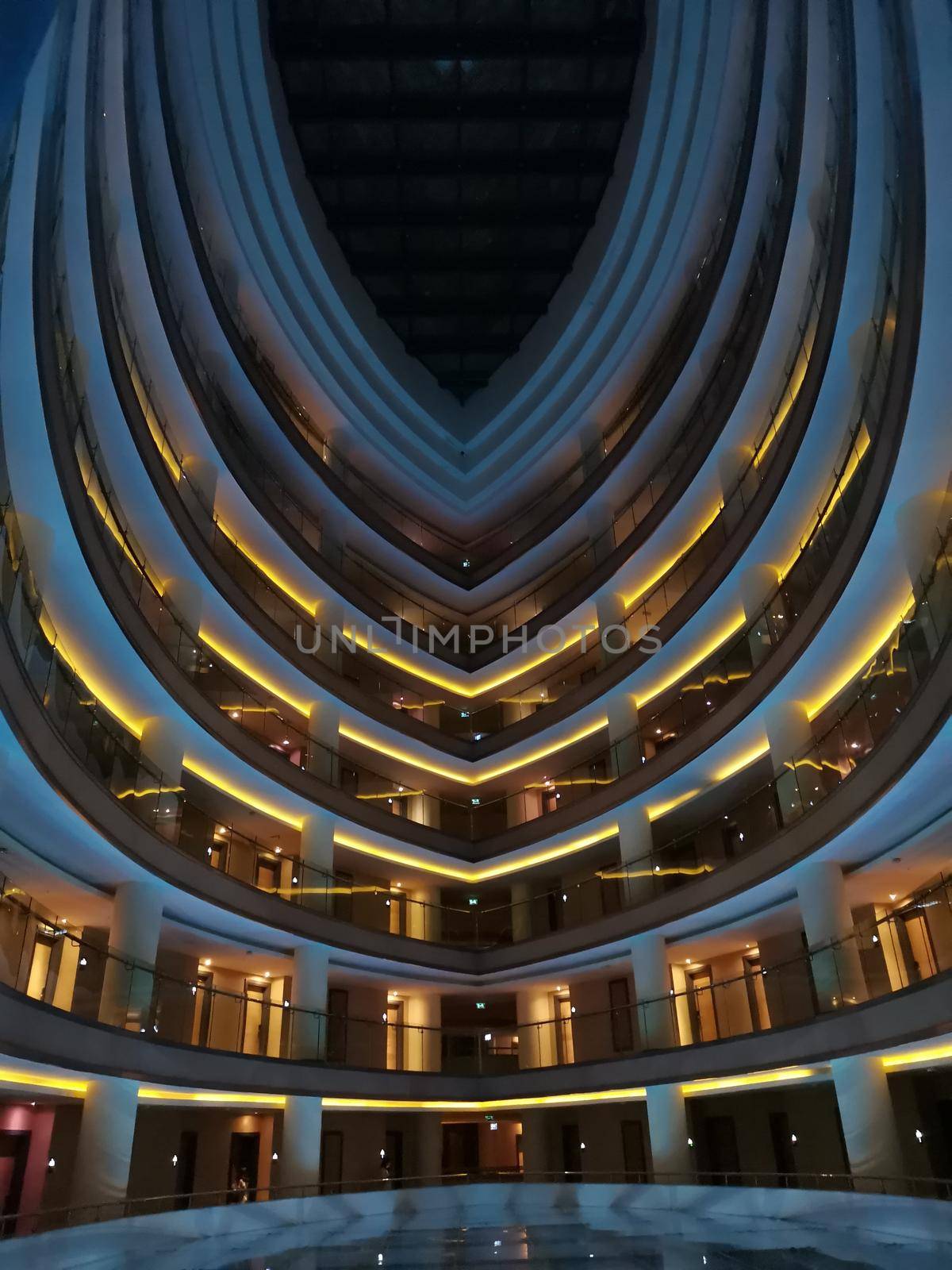 Modern abstract building. Fashionable architecture of multistory building. Evening futuristic view with backlight