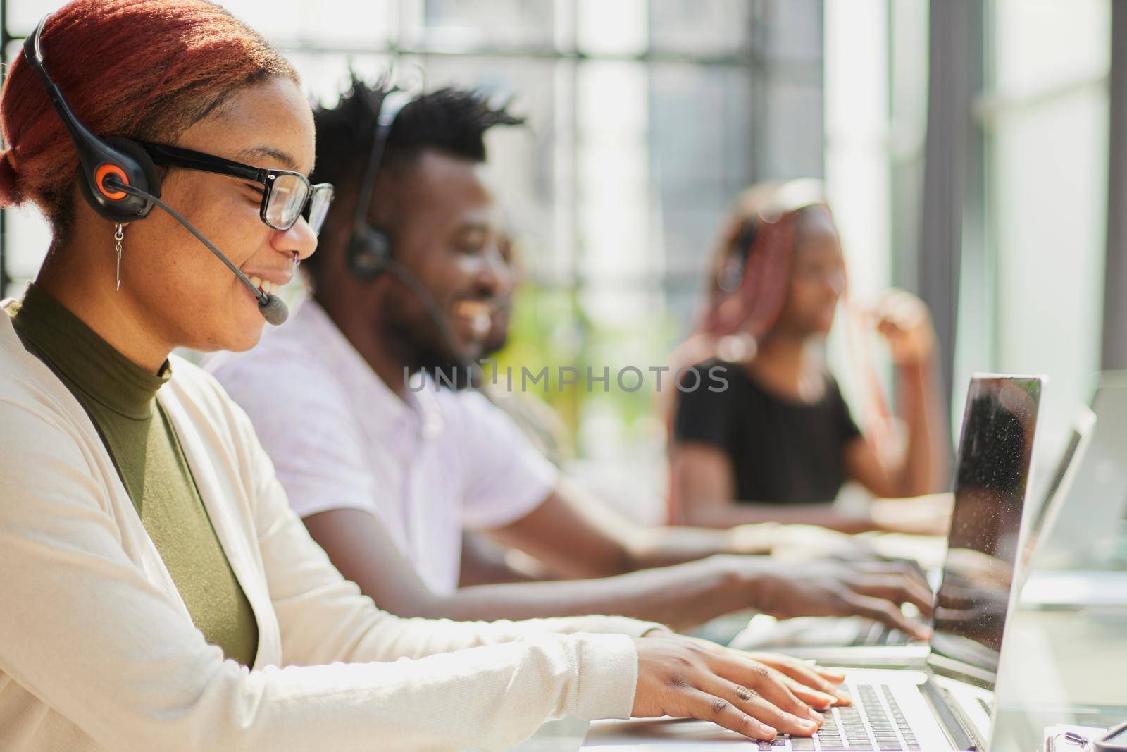 Call Center Operator With Colleagues At Workplace