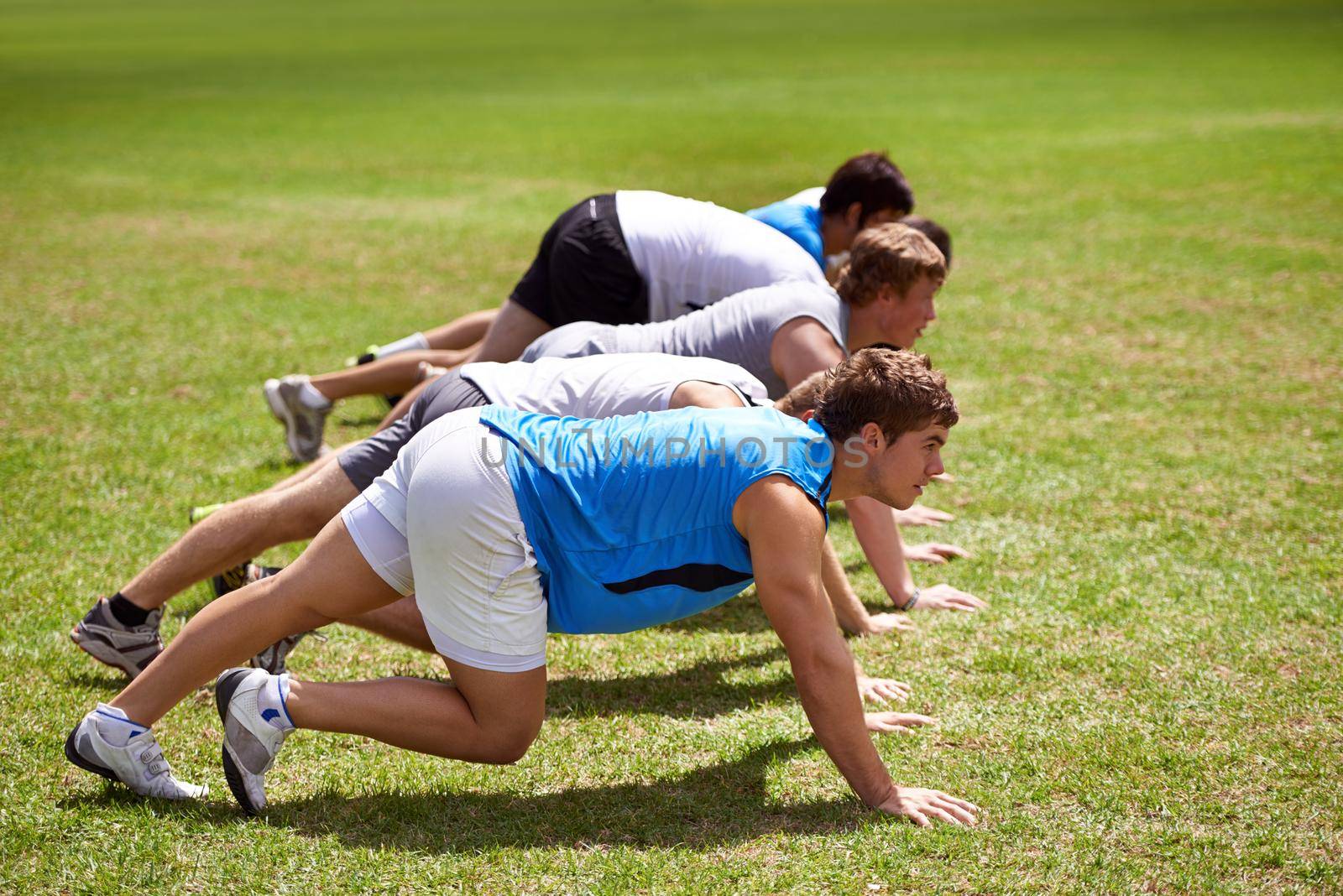 Its all worth it in the end. young sportsmen training outdoors. by YuriArcurs