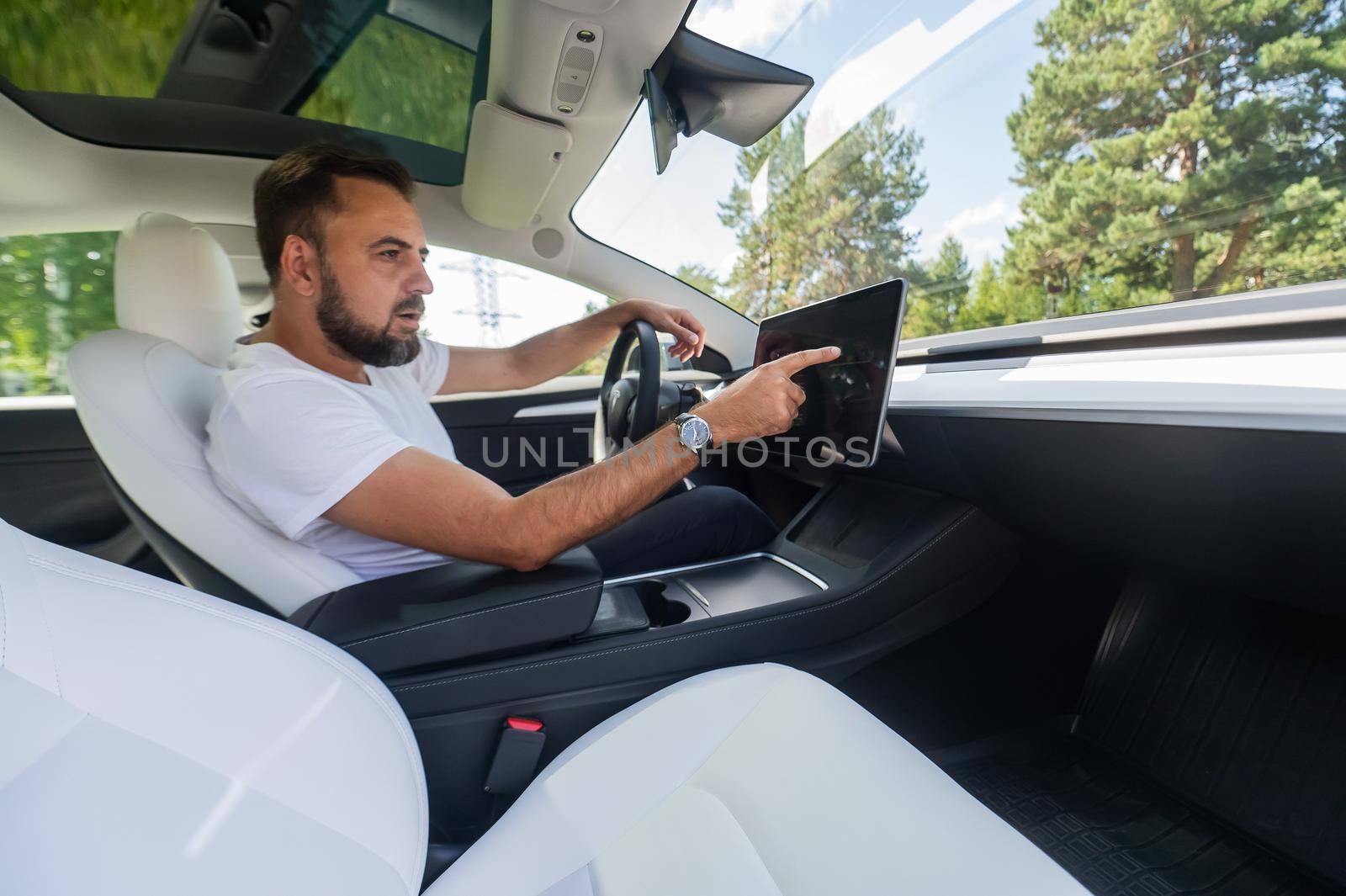 Caucasian man driving a modern electric car