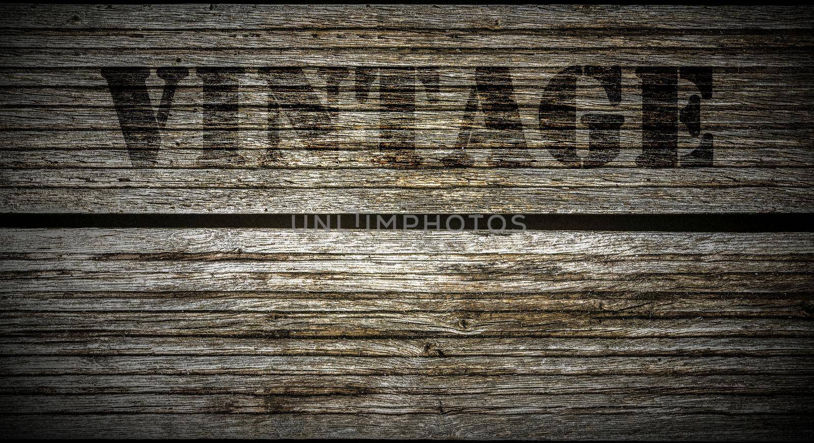 A stamp with the lettering Vintage on an old wooden background. by MP_foto71