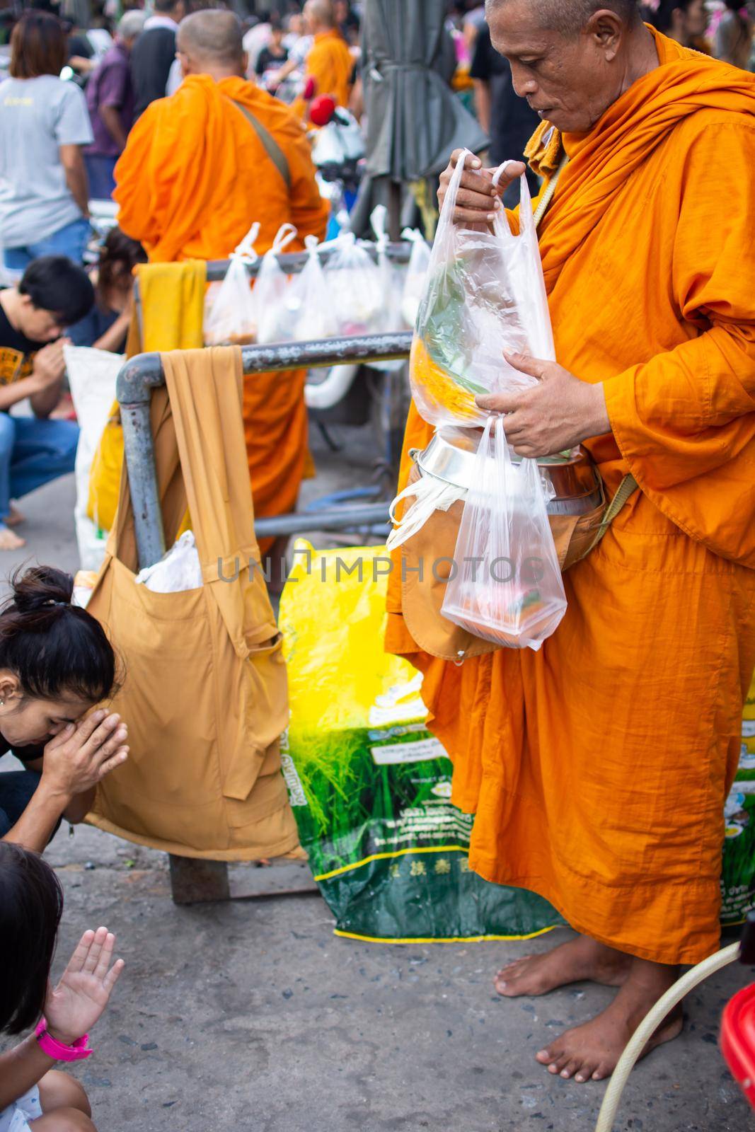 Thai monk ask for alms for buddhist to make merit by PongMoji