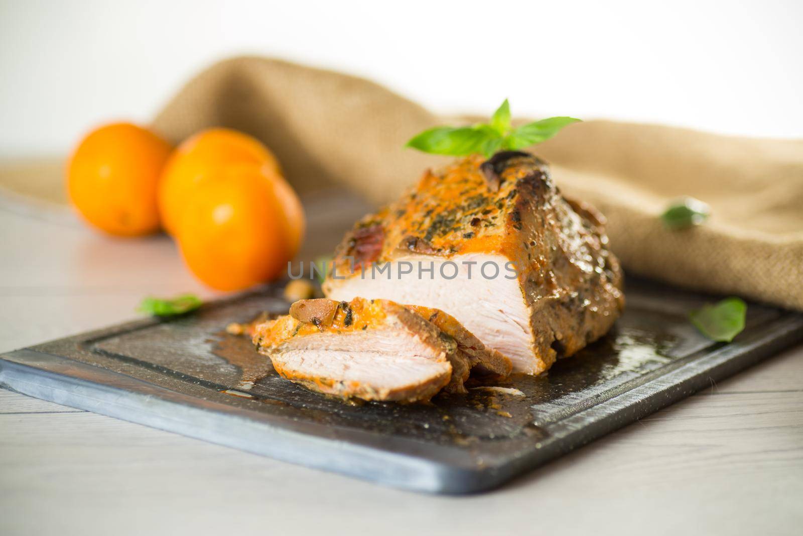 Baked sirloin turkey meat homemade with spices, on a wooden table.