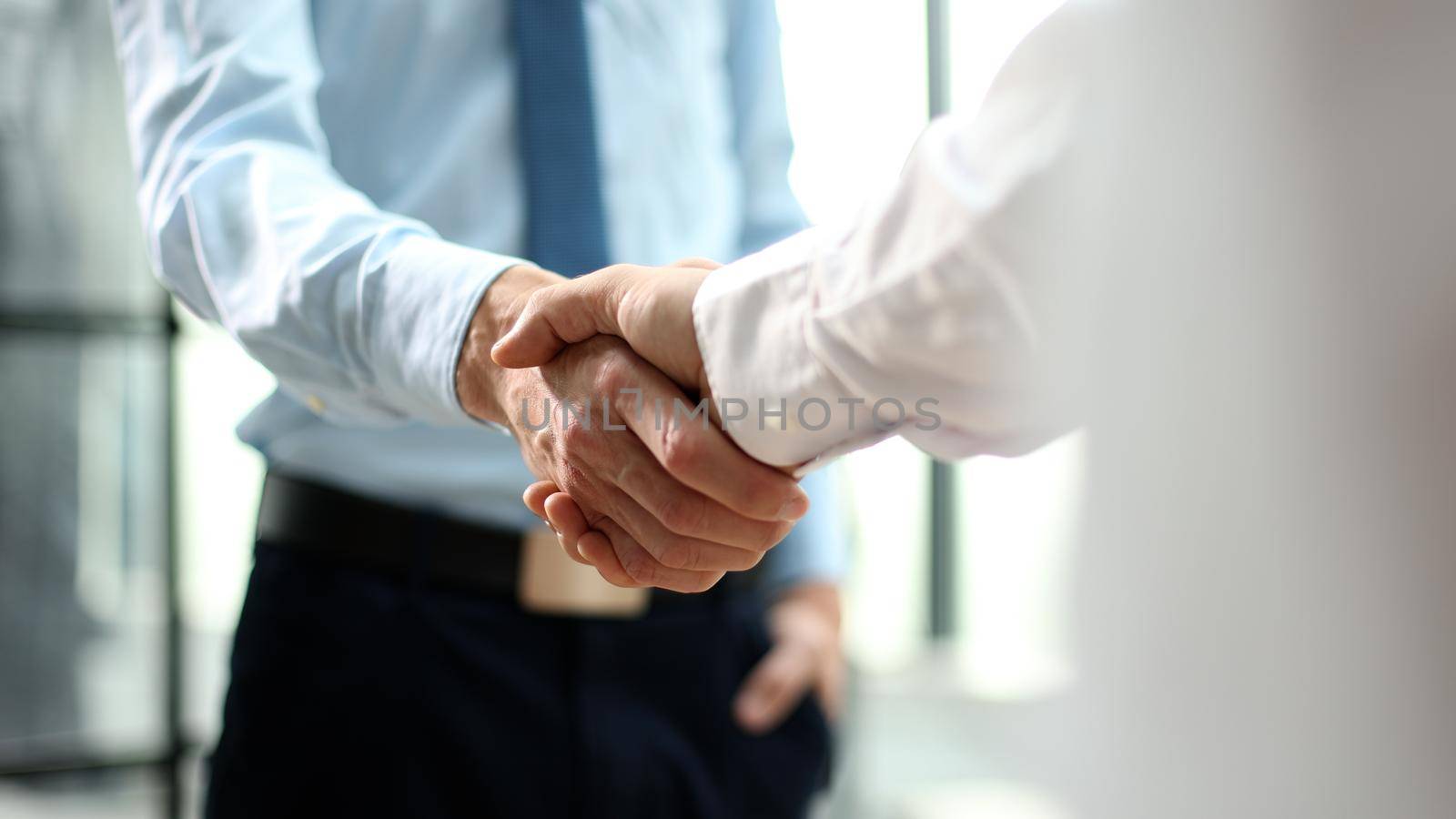Cropped view of african american businessman shaking hands with colleague in office