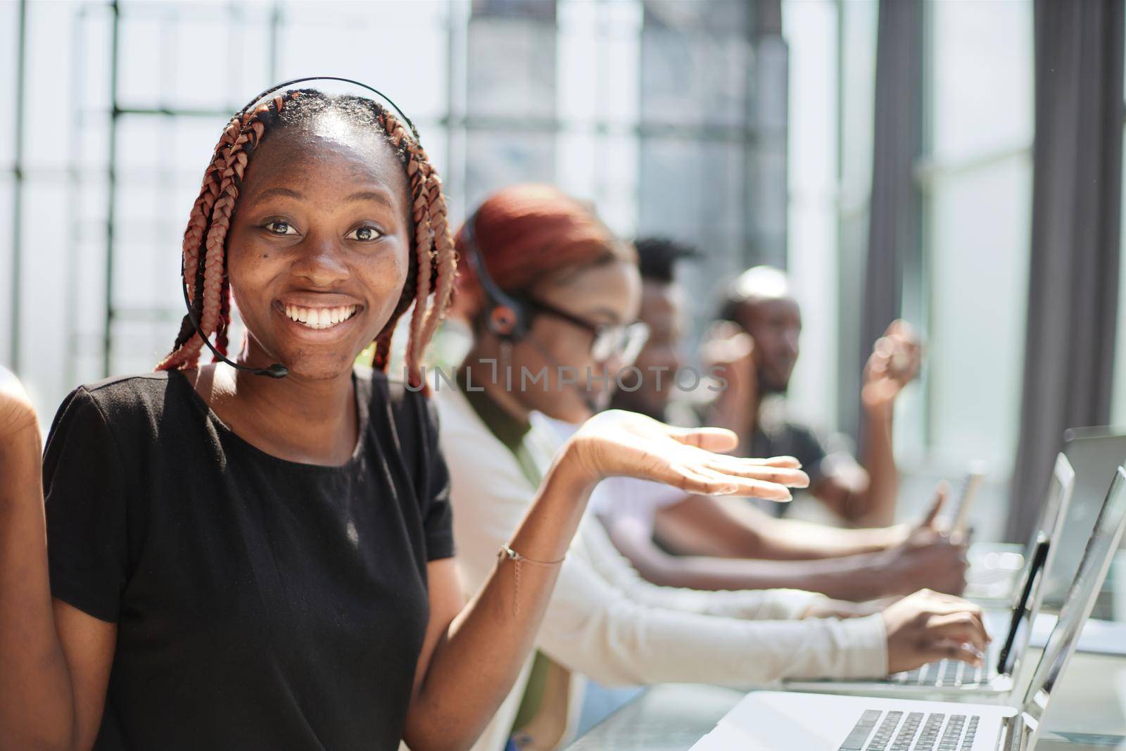 Call Center Operator With Colleagues At Workplace