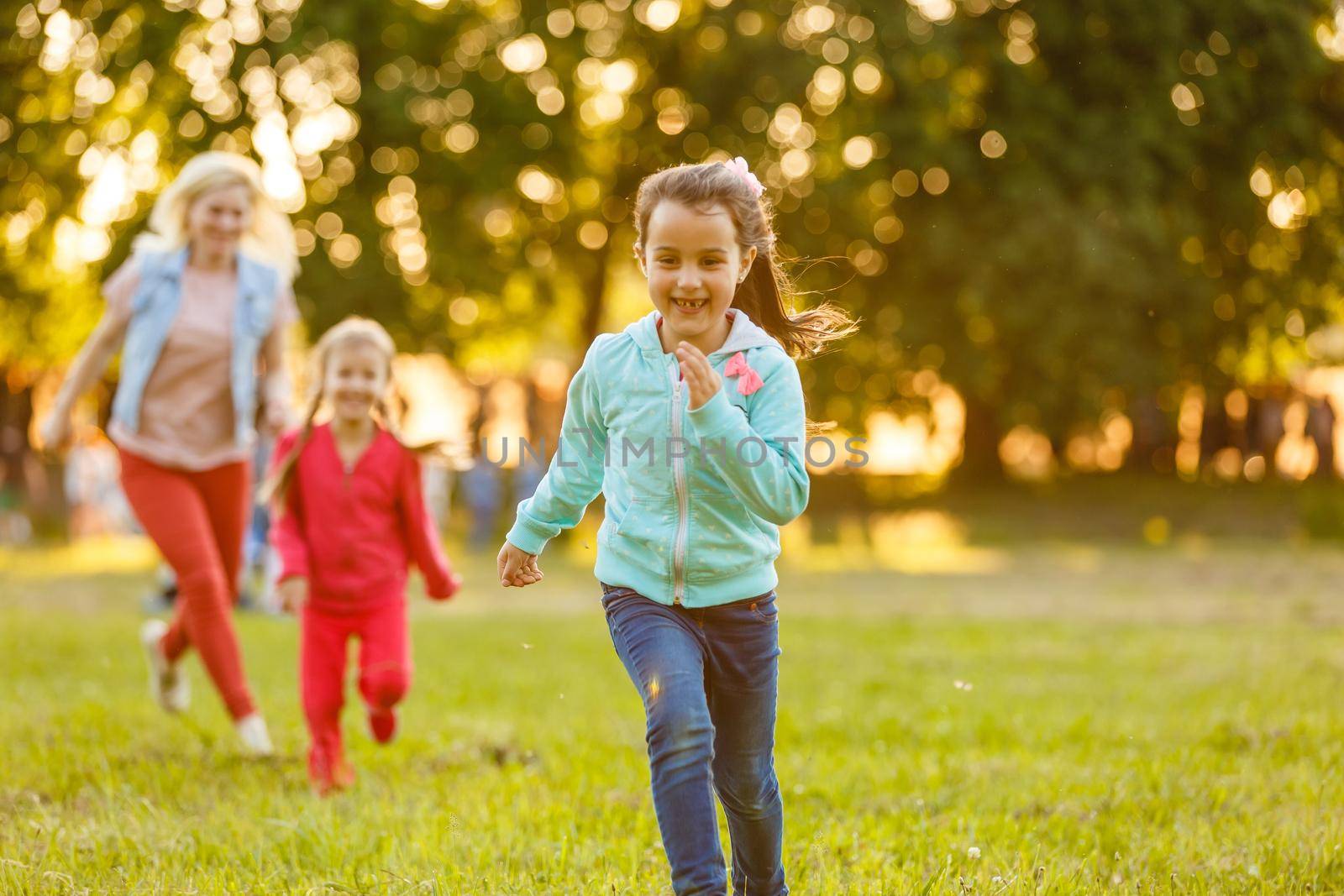 Summer fun. little girls play in the field