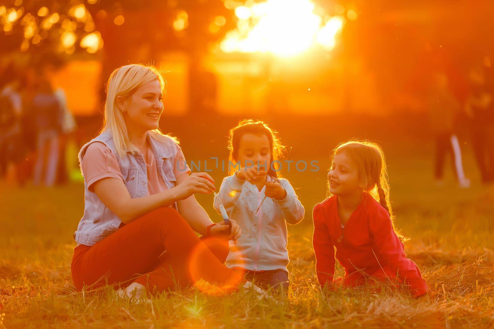 Two little girls are blowing soap bubbles, outdoor shoot