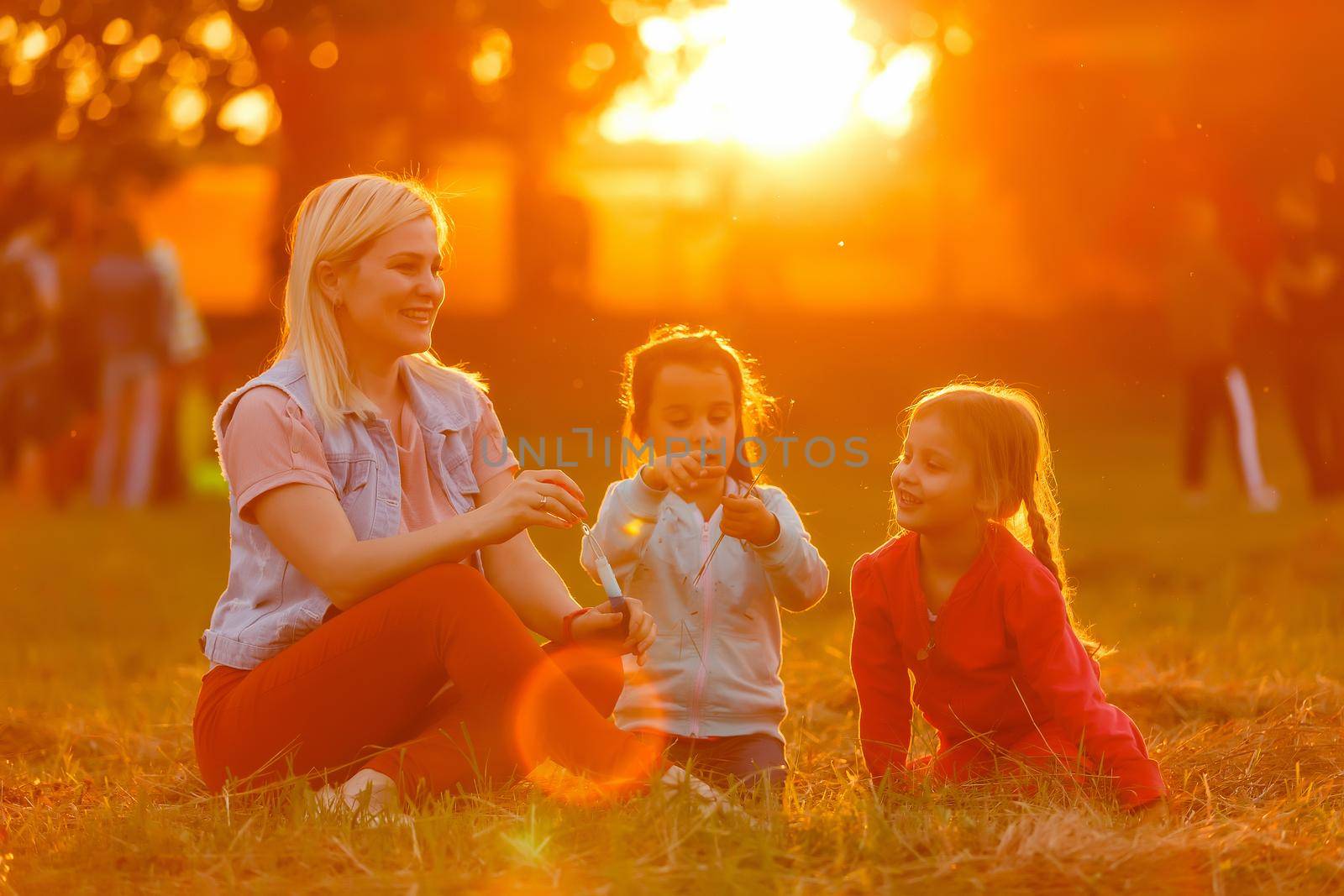 Two little girls are blowing soap bubbles, outdoor shoot by Andelov13