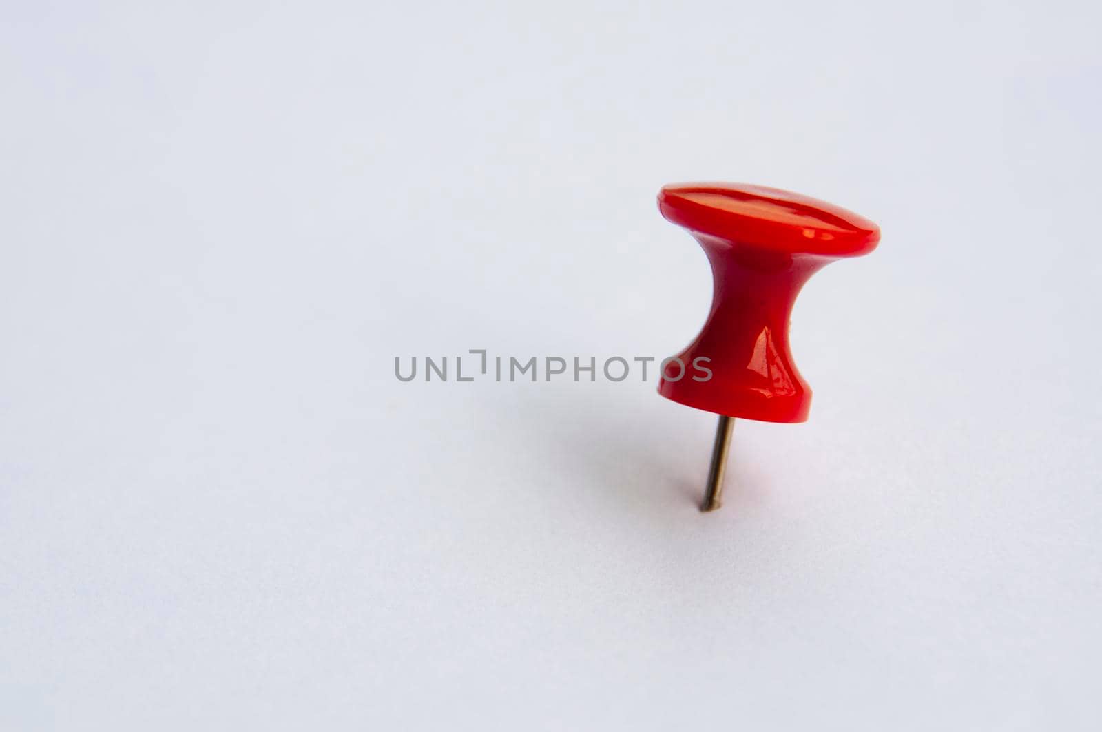 Red push pins isolated on white background. Copy space.