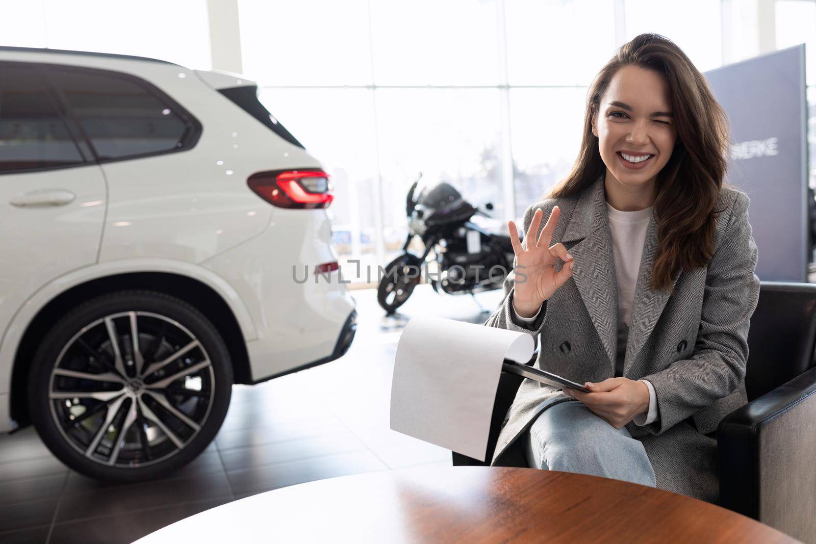 a young woman bought and insured her new car at a car dealership.