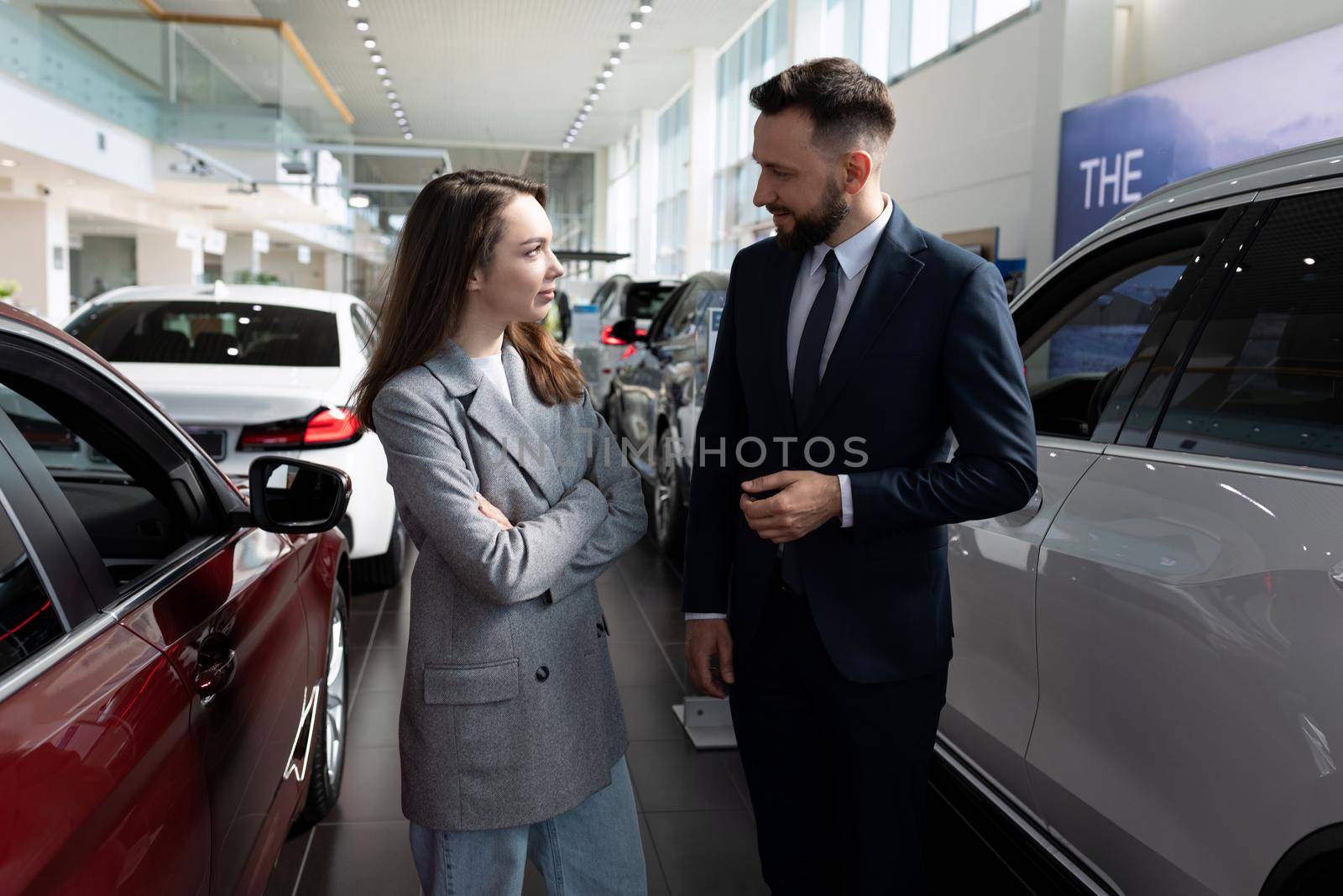 car dealership employees communicate among new cars by TRMK