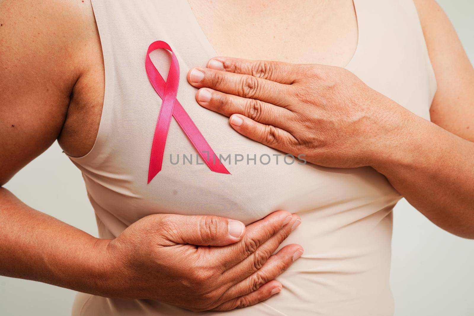 Asian woman with pink ribbon, World Breast Cancer Day at October.