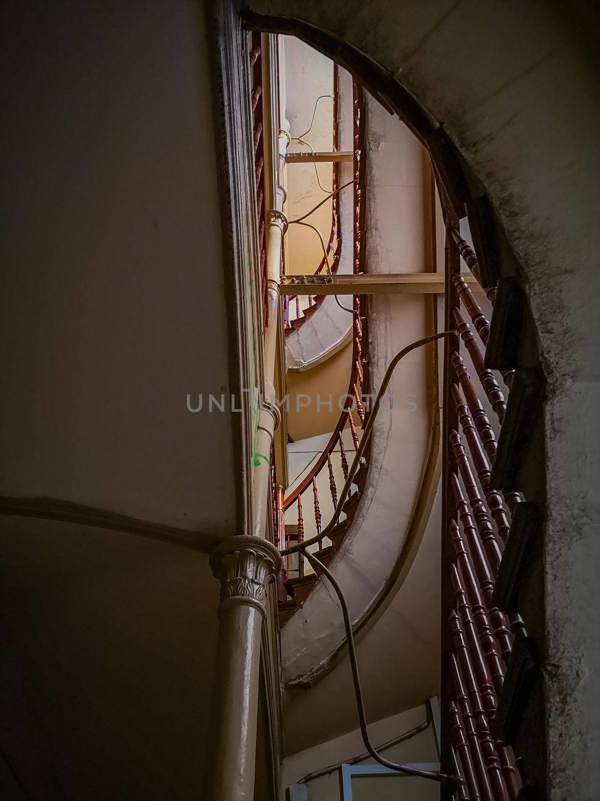 Looking up to Spiral staircase with metal and wooden railings by Wierzchu