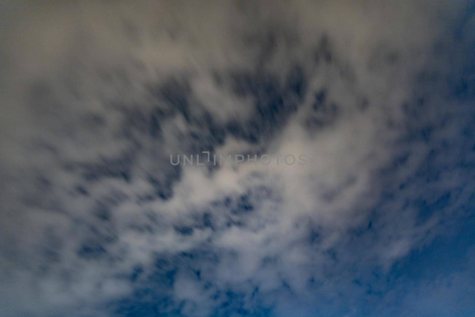 Dark blue sky on long exposure with moving clouds at night 