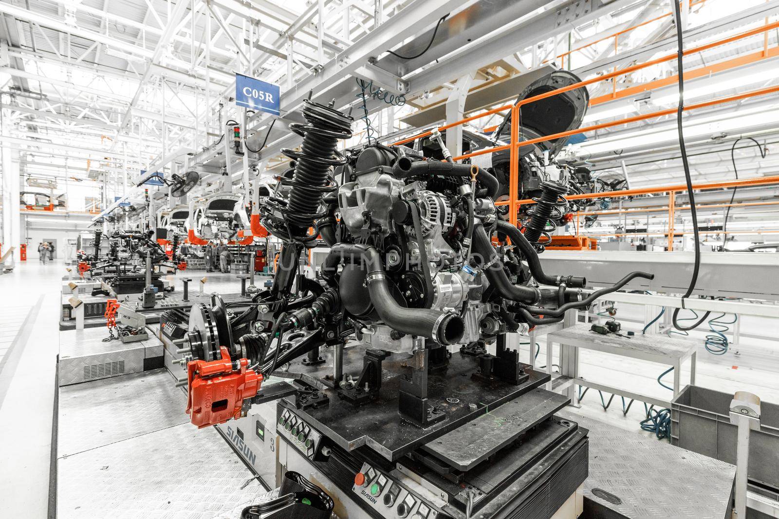 Photo of automobile production line. Welding car body. Modern car assembly plant. Auto industry. Interior of a high-tech factory, modern production.