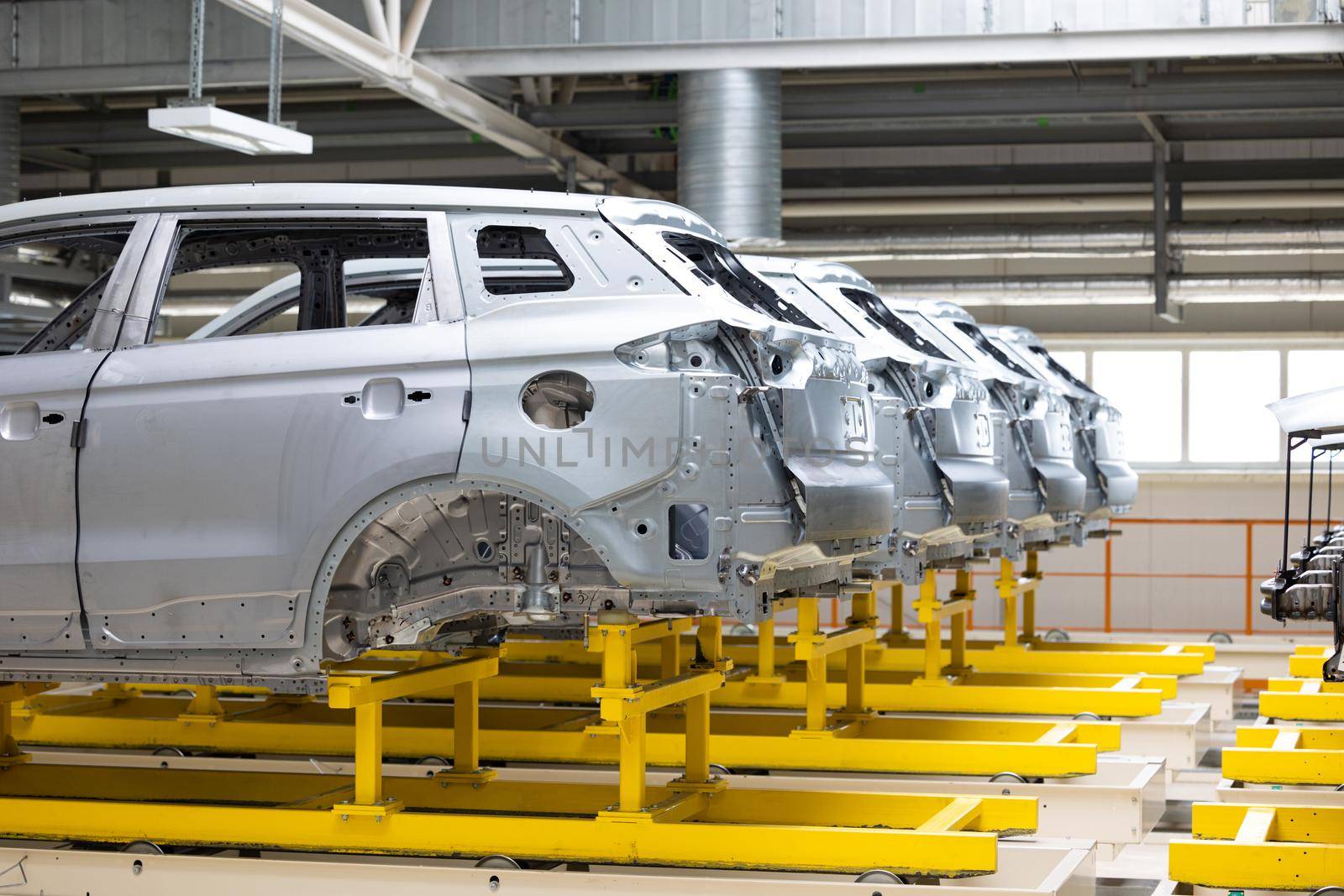 Photo of automobile production line. Welding car body. Modern car assembly plant. Auto industry. High-tech factory.