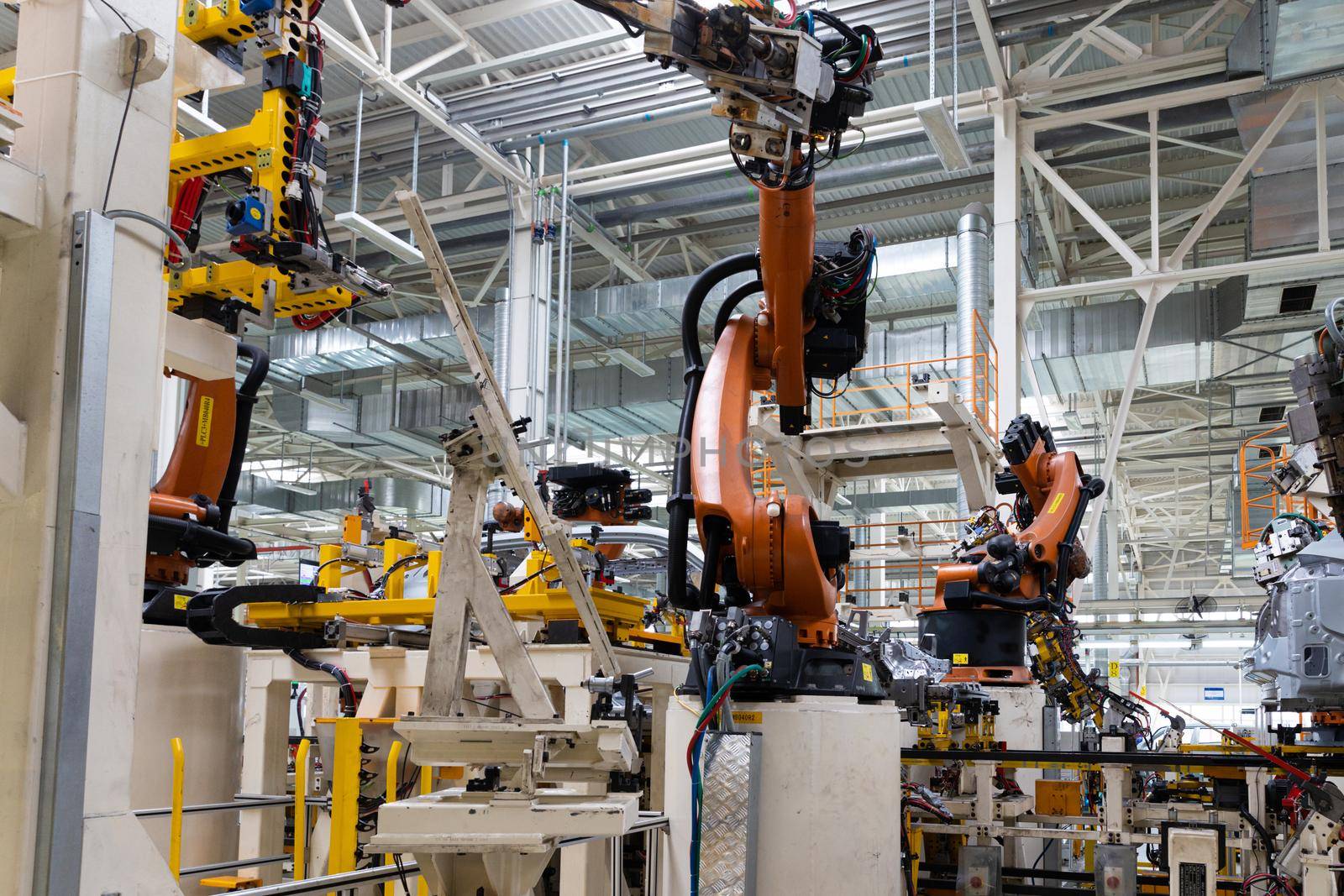 Photo of automobile production line. Modern car assembly plant. Auto industry. Interior of a high-tech factory, modern production.