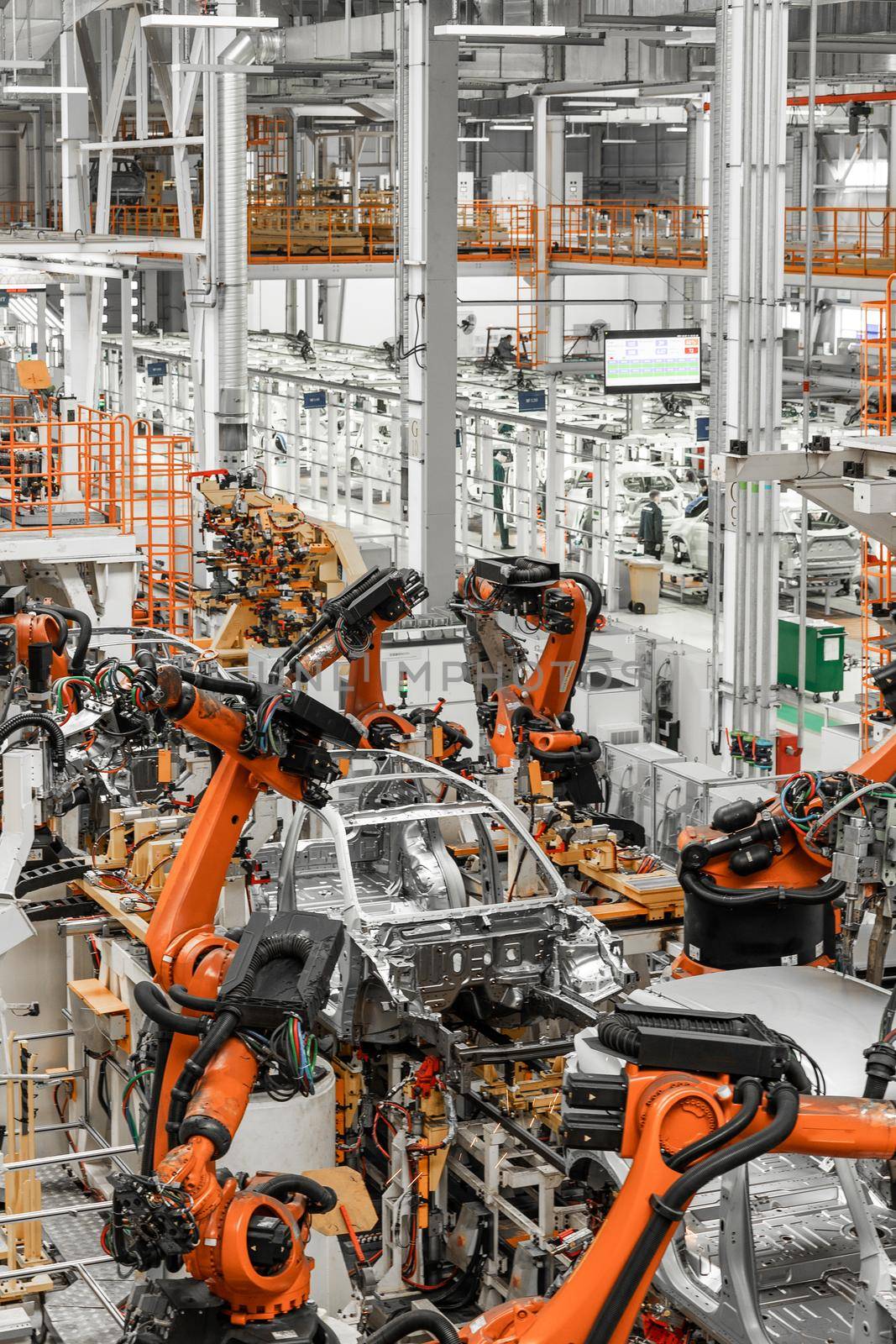 Vertical photo of automobile production line. Modern car assembly plant. Auto industry. Interior of a high-tech factory, modern production by TRMK