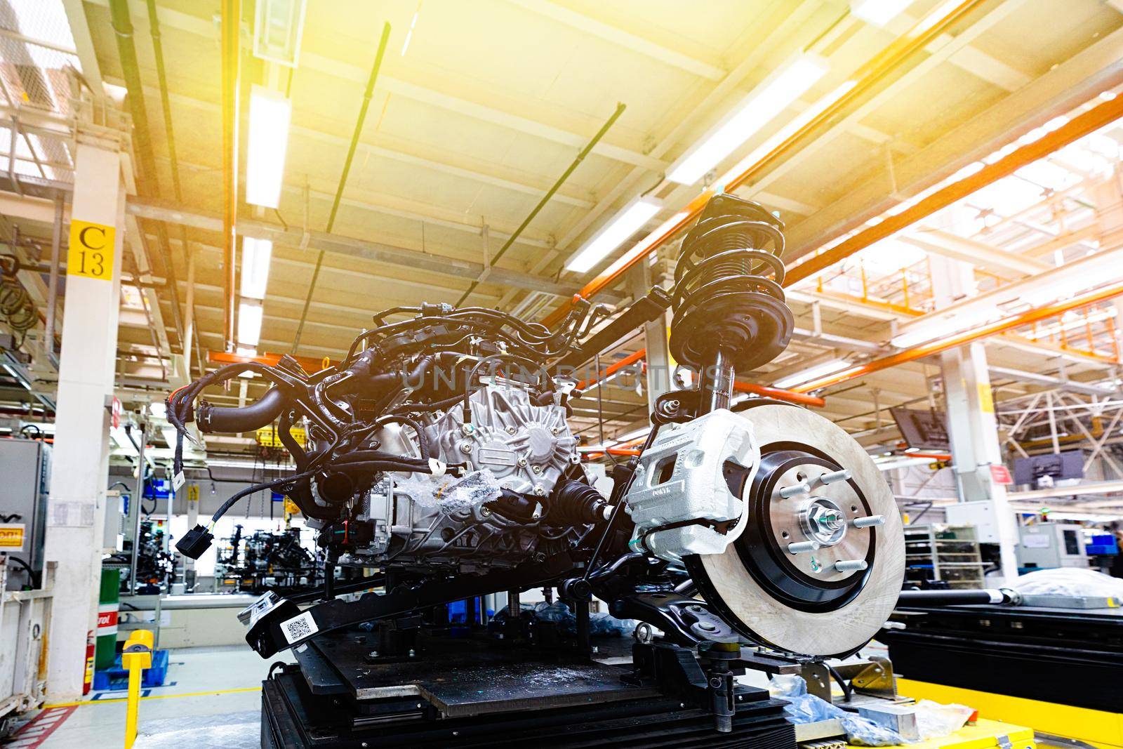 Photo of car bodies are on assembly line. Factory for production of cars. Modern automotive industry. Yellow tone.