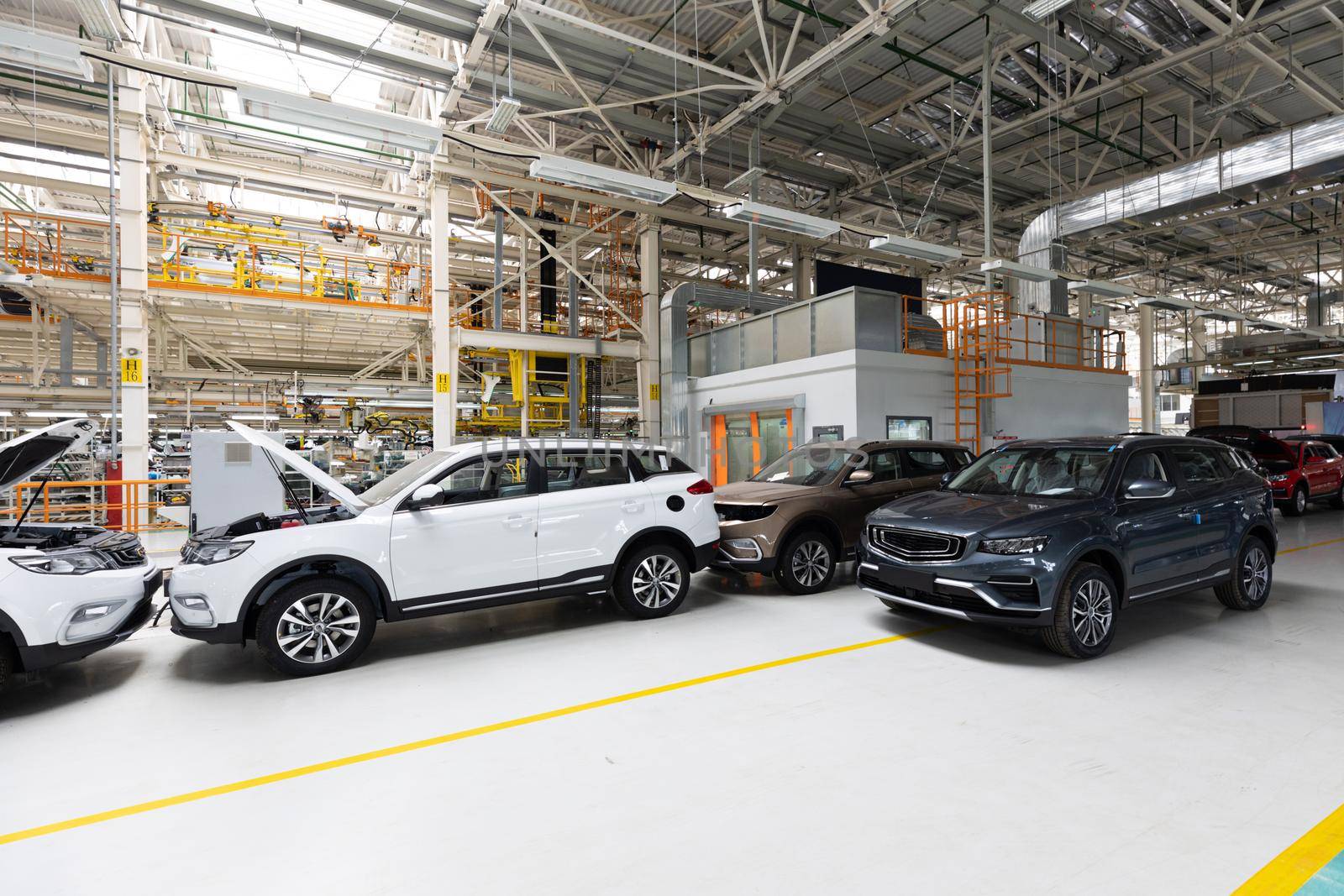 Modern car assembly plant. Auto industry. Interior of a high-tech factory, modern production of automobiles.