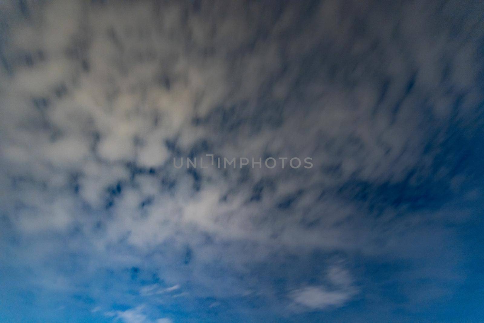 Dark blue sky on long exposure with moving clouds at night  by Wierzchu