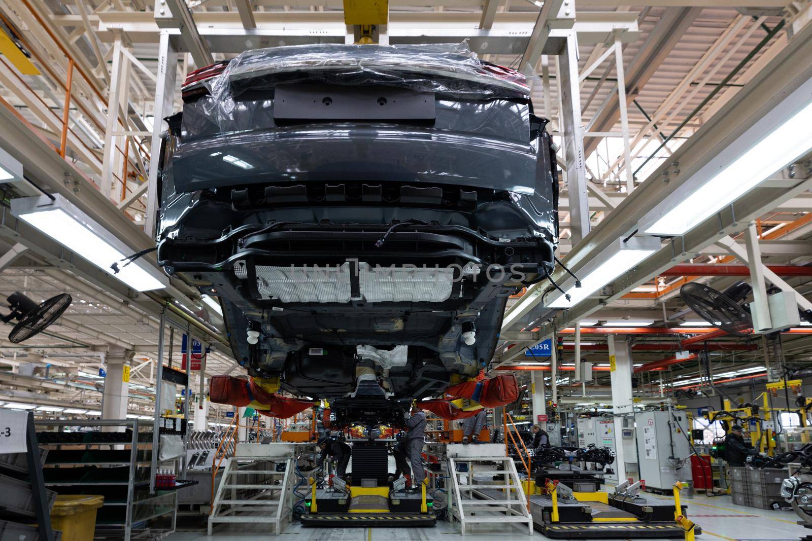 Minsk, Belarus - Dec 15, 2021: Automobile production line. Modern car assembly plant. Interior of a high-tech factory, manufacturing.