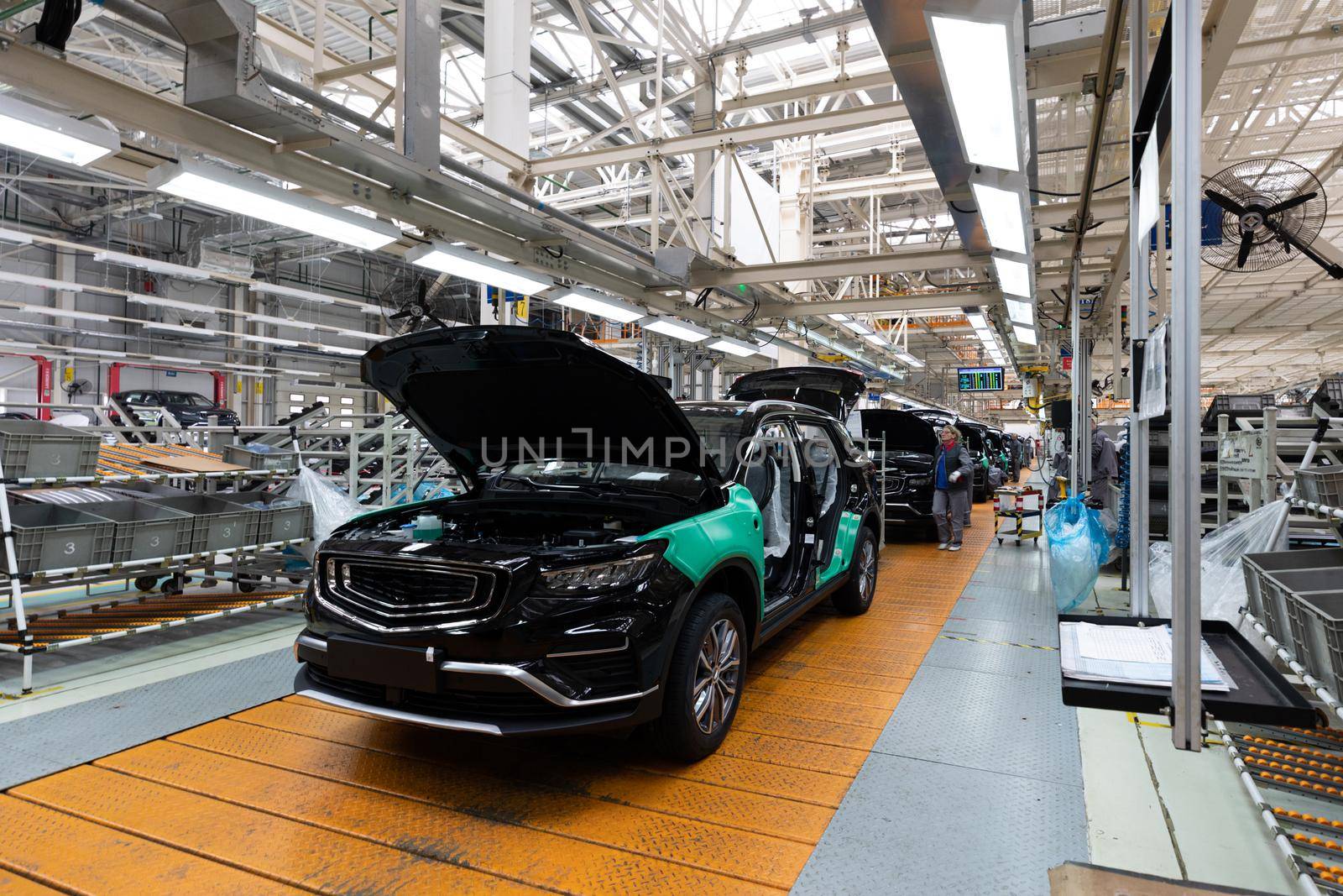 Minsk, Belarus - Dec 15, 2021: Photo of modern car assembly plant. Interior of a high-tech factory of new automobiles.