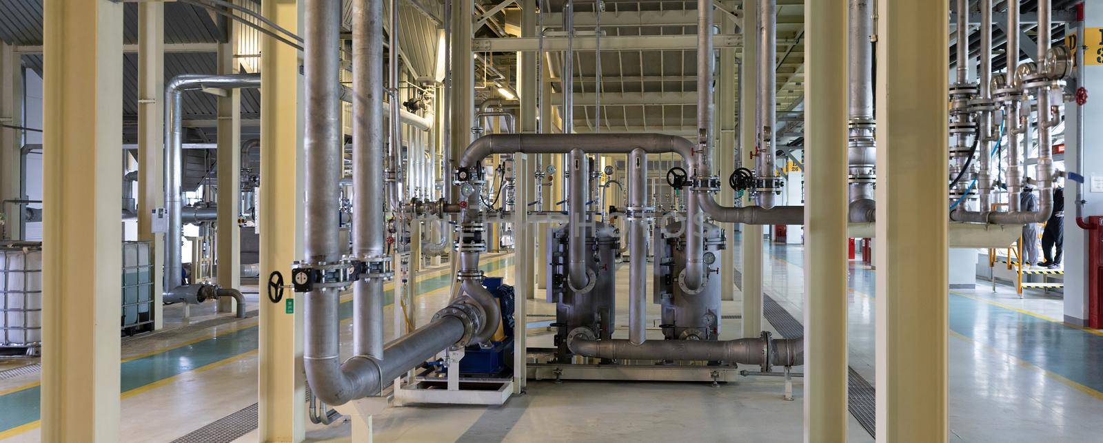 Panoramic photo of pipes and tanks. Chemistry and medicine production. Pharmaceutical factory.