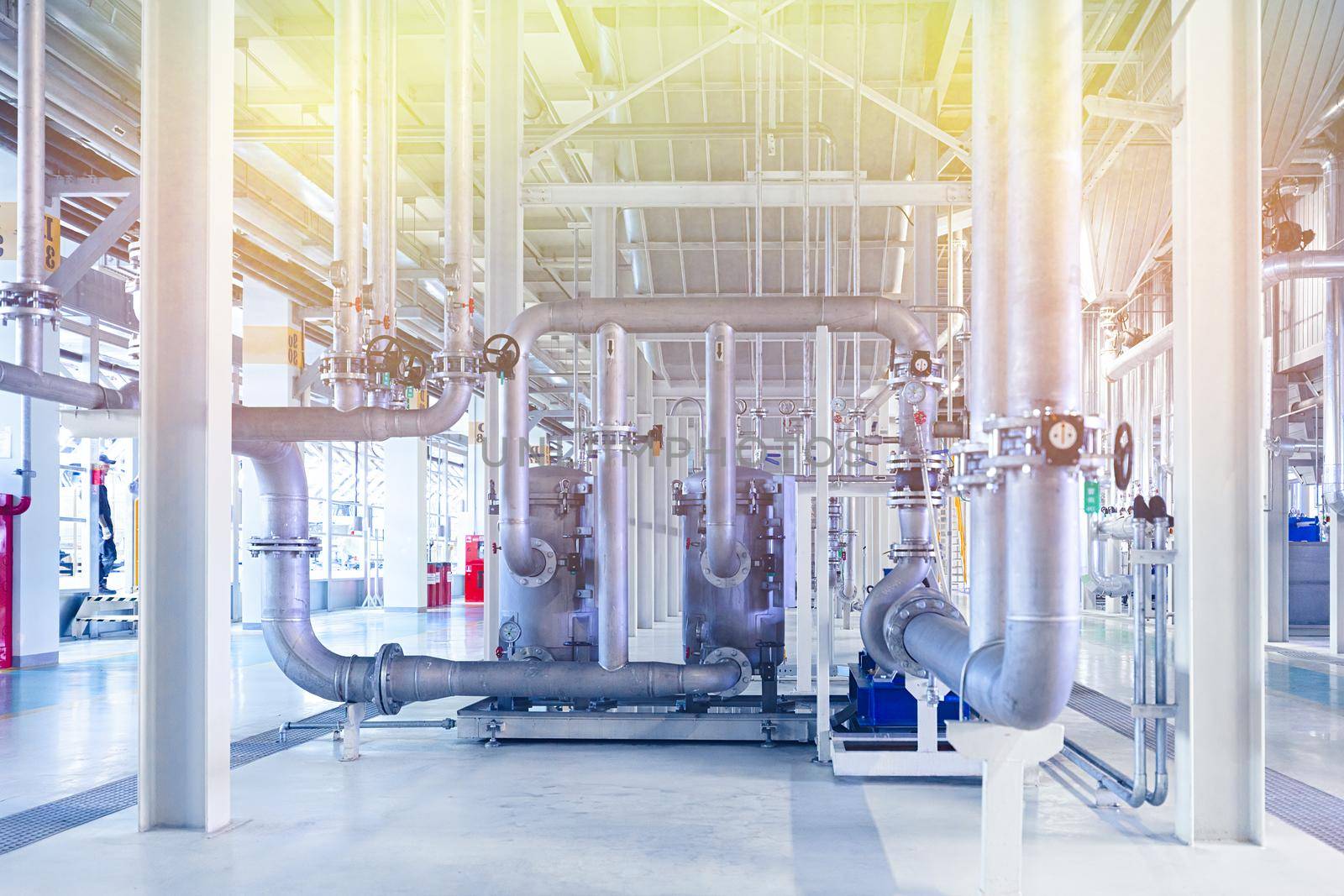 Photo of pipes and tanks. Chemistry and medicine production. Pharmaceutical factory. Yellow light tone.