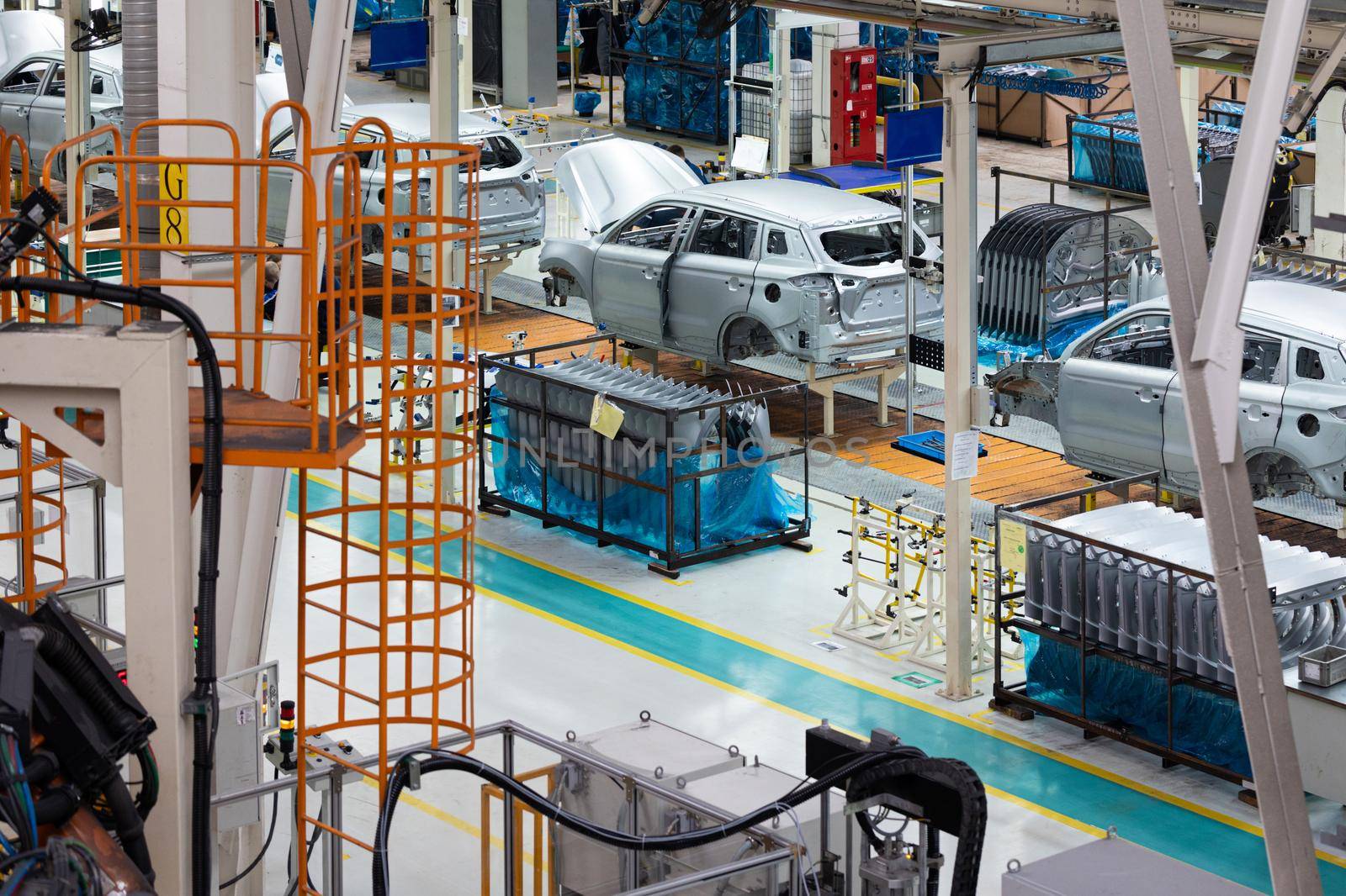 Car bodies are on assembly line. Factory for production of cars. Modern automotive industry. Electric car factory, conveyor.