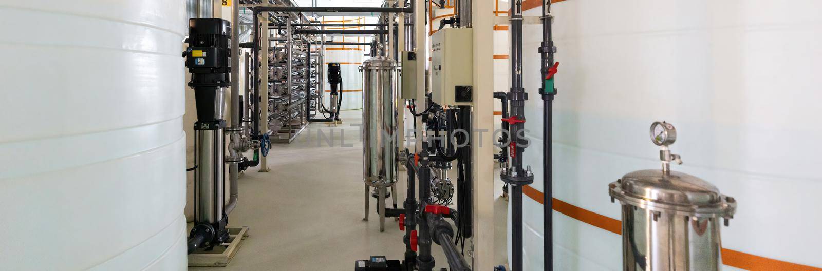 Panoramic photo of pipes and tanks. Chemistry and medicine production. Pharmaceutical factory. Interior of a high-tech factory, modern production.