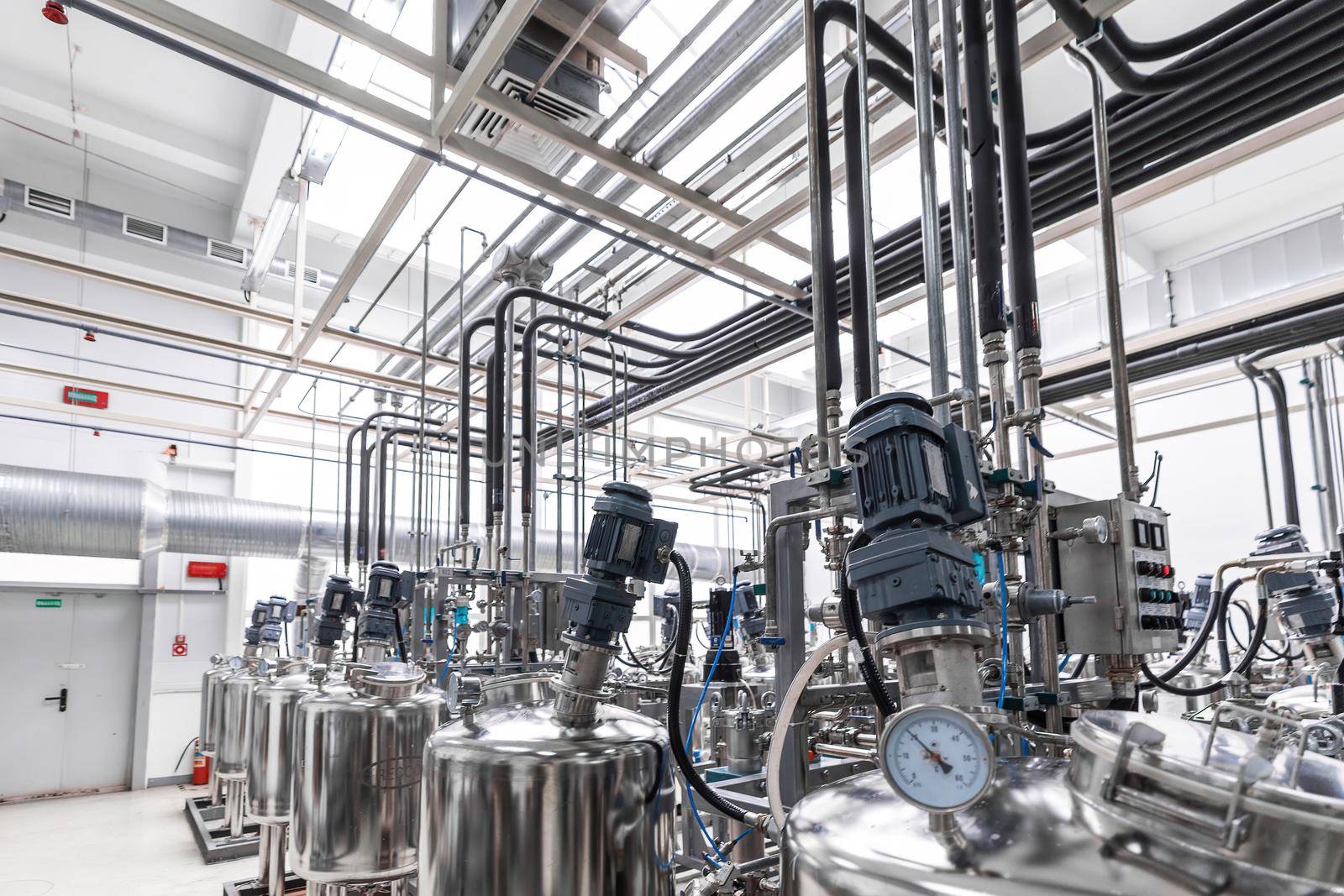 Photo of pipes and tanks. Chemistry and medicine production. Pharmaceutical plant. Interior of a high-tech factory, modern production.