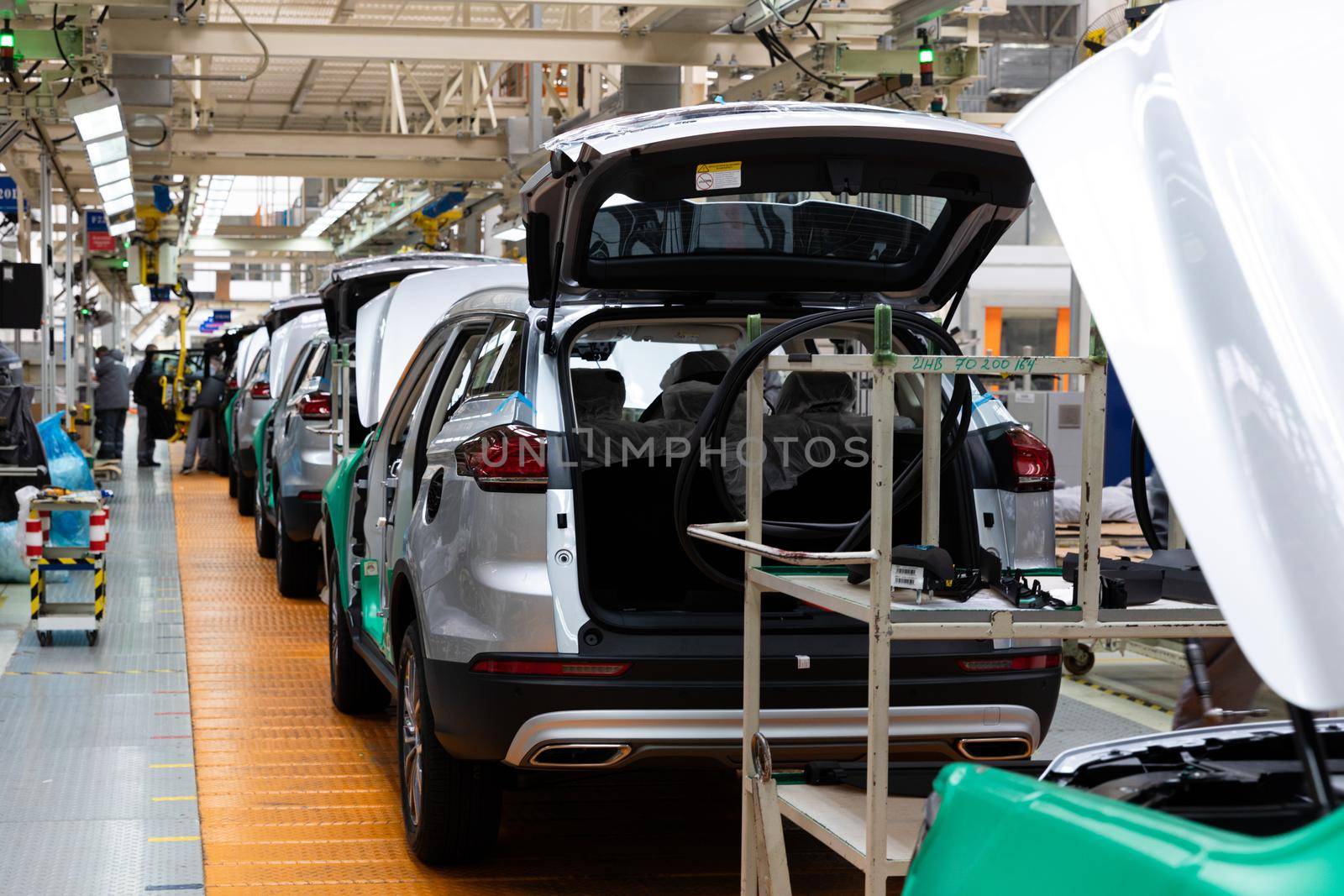 Car bodies are on assembly line. Factory for production of cars. Modern automotive industry. Electric car factory, conveyor.