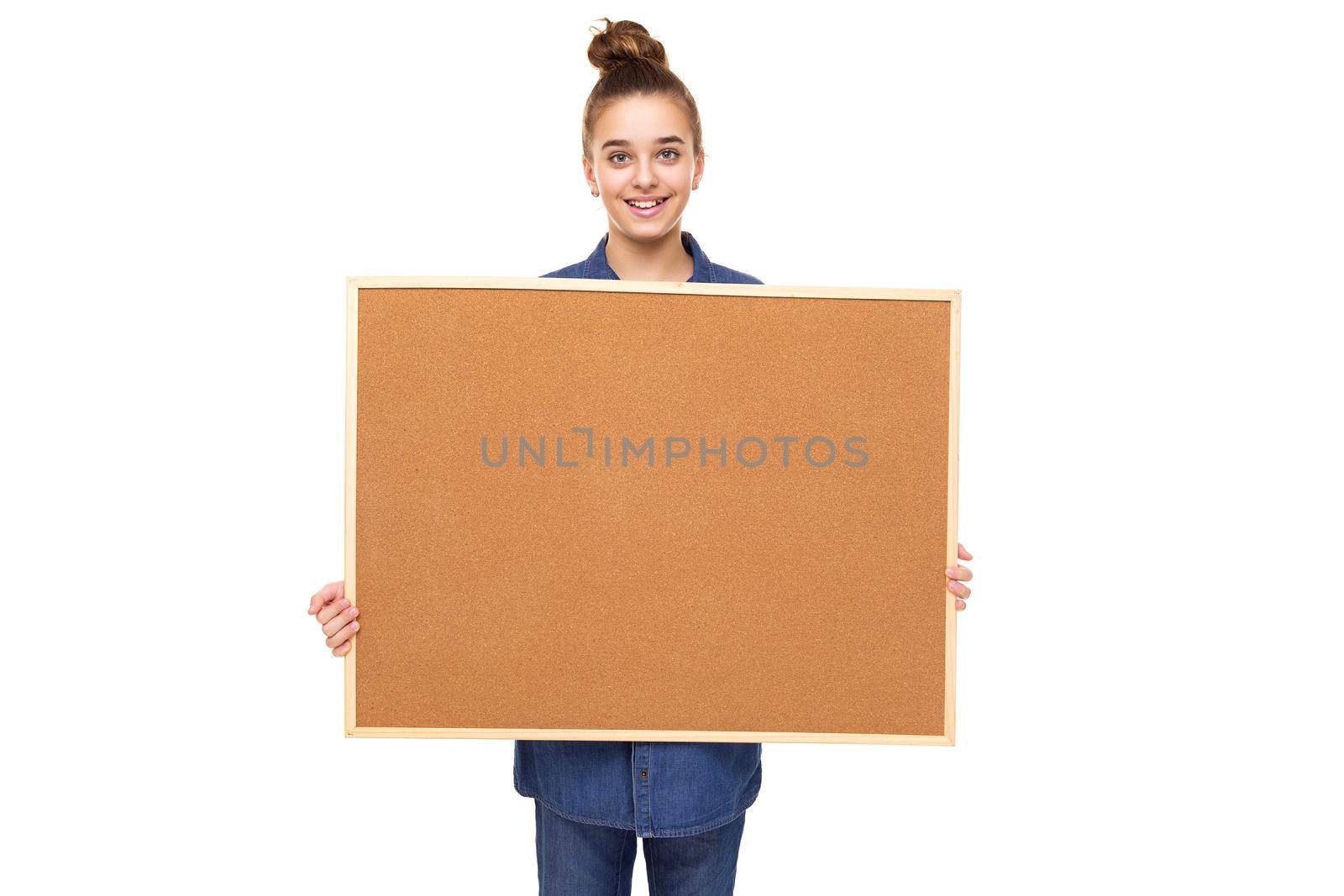 Photo of a beautiful cute smiling girl with dark hair and a bun in a brown hoodie with a hood isolated on a white background with a place for text.