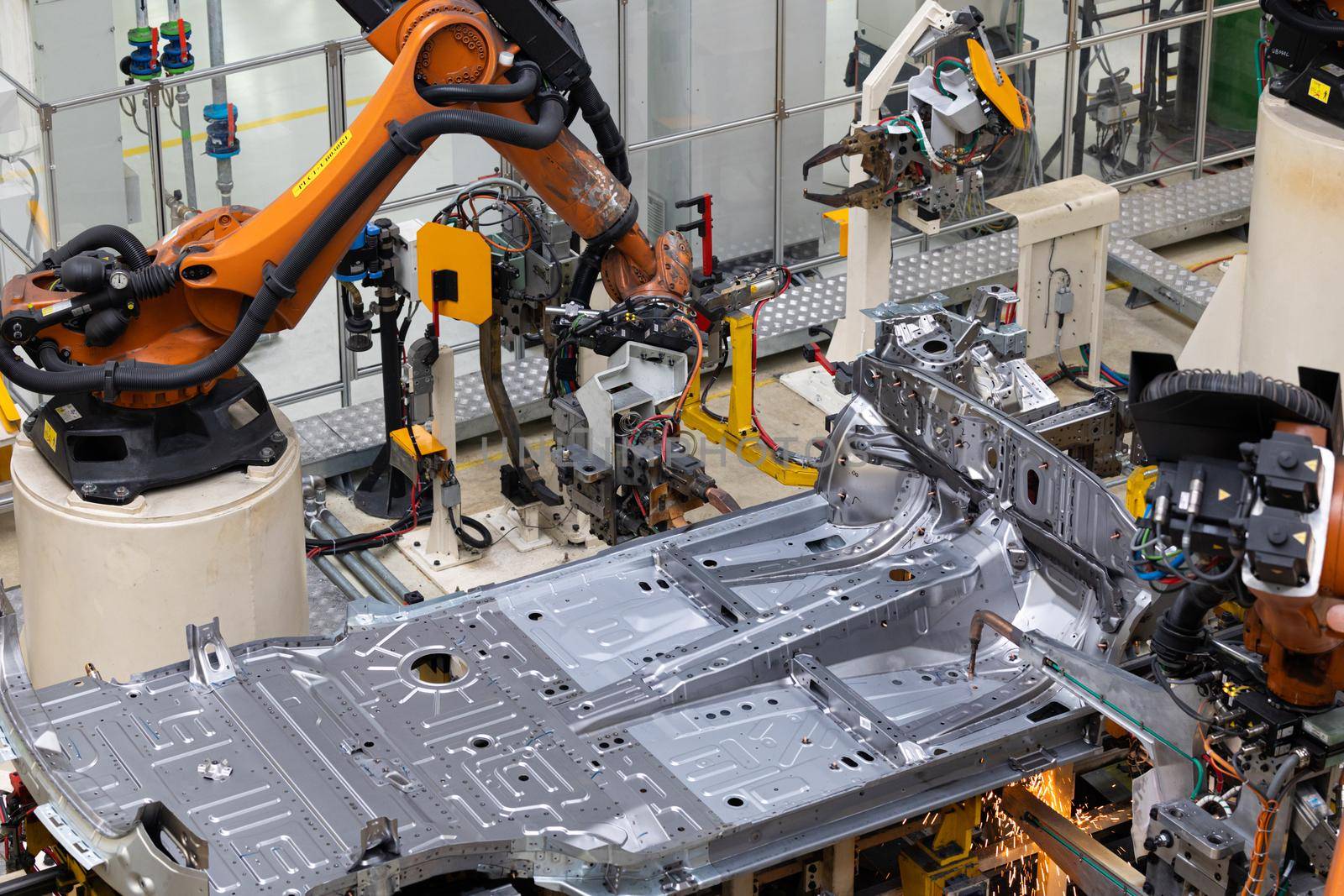 Photo of automobile production line. Welding car body. Modern car assembly plant. Auto industry. Interior of a high-tech factory, modern production.