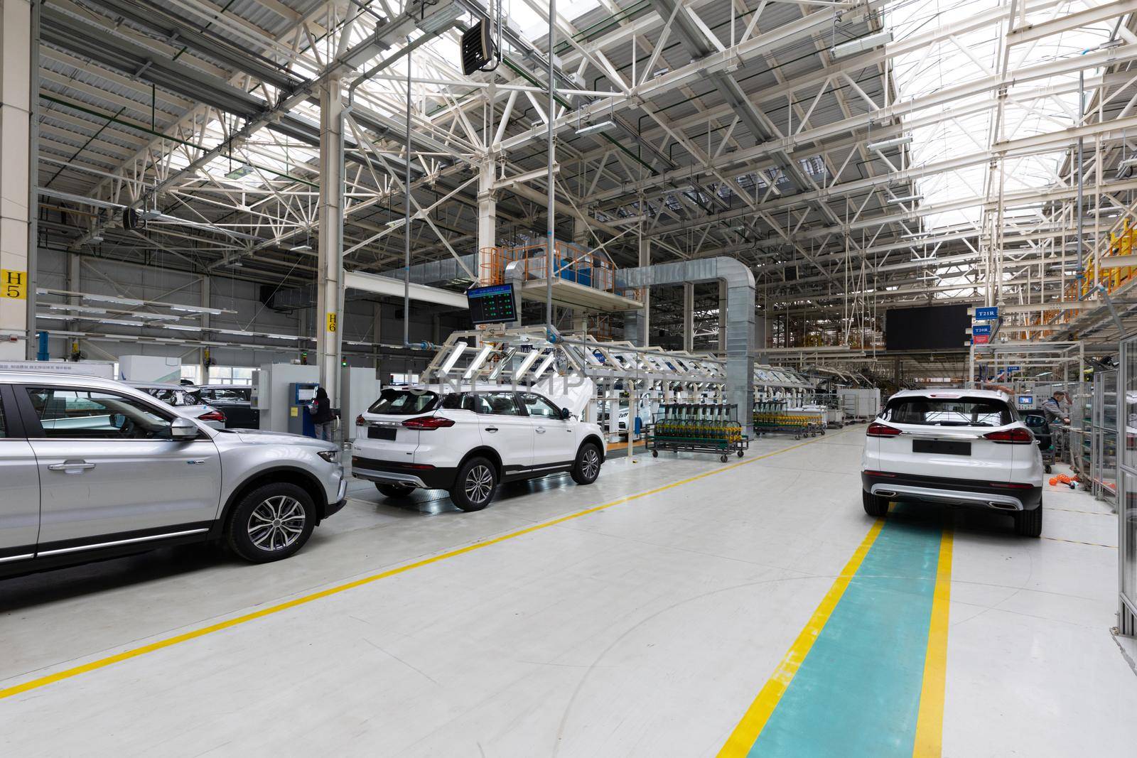 Automobile production line. Modern car assembly plant. Interior of a high-tech factory, manufacturing.