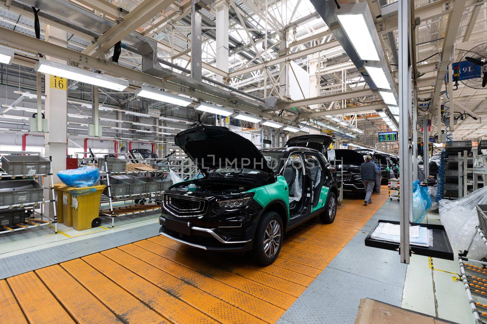 Photo of modern car assembly plant. Interior of a high-tech factory of new automobiles.