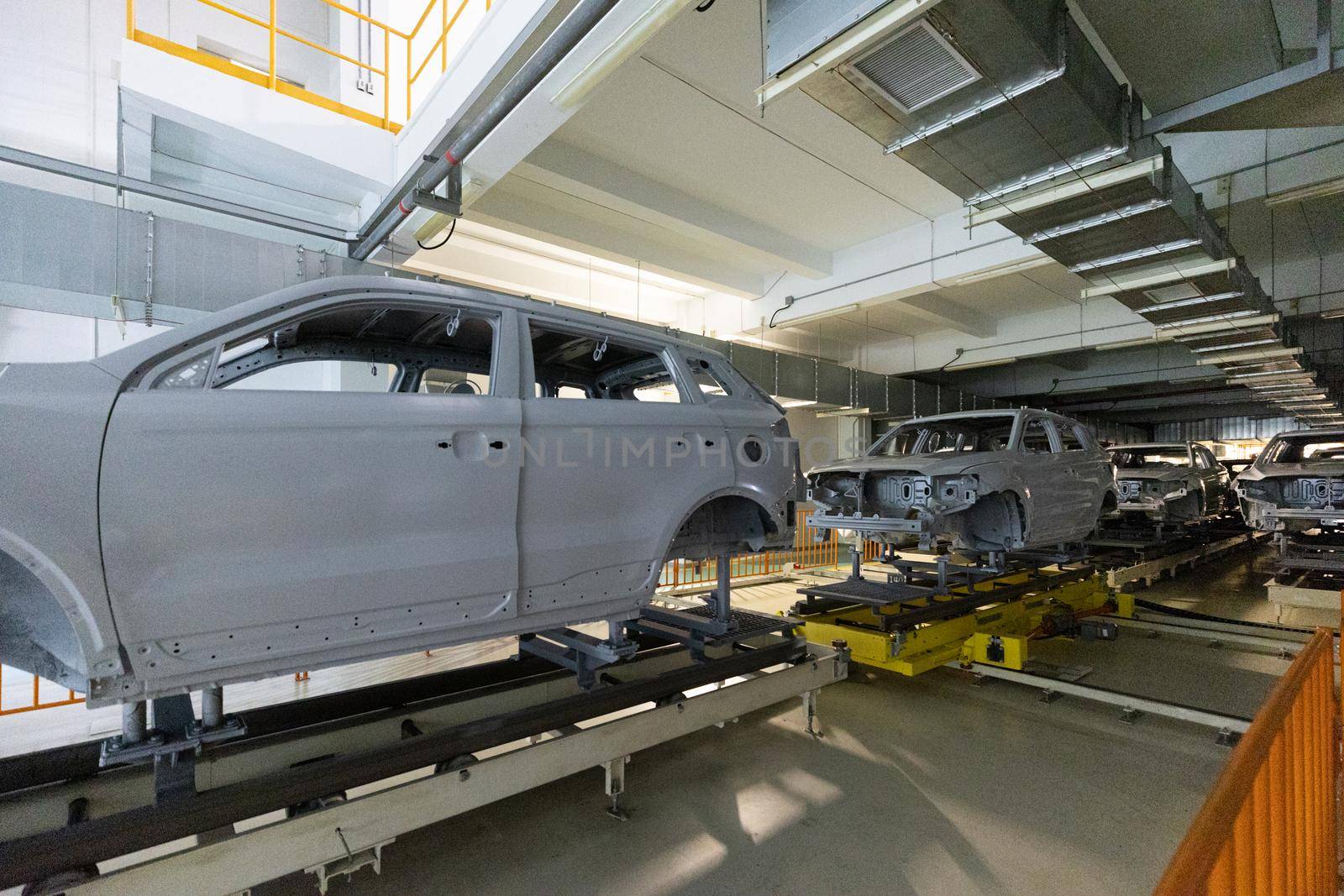 Car bodies are on assembly line. Modern automotive industry. Automobile conveyor.