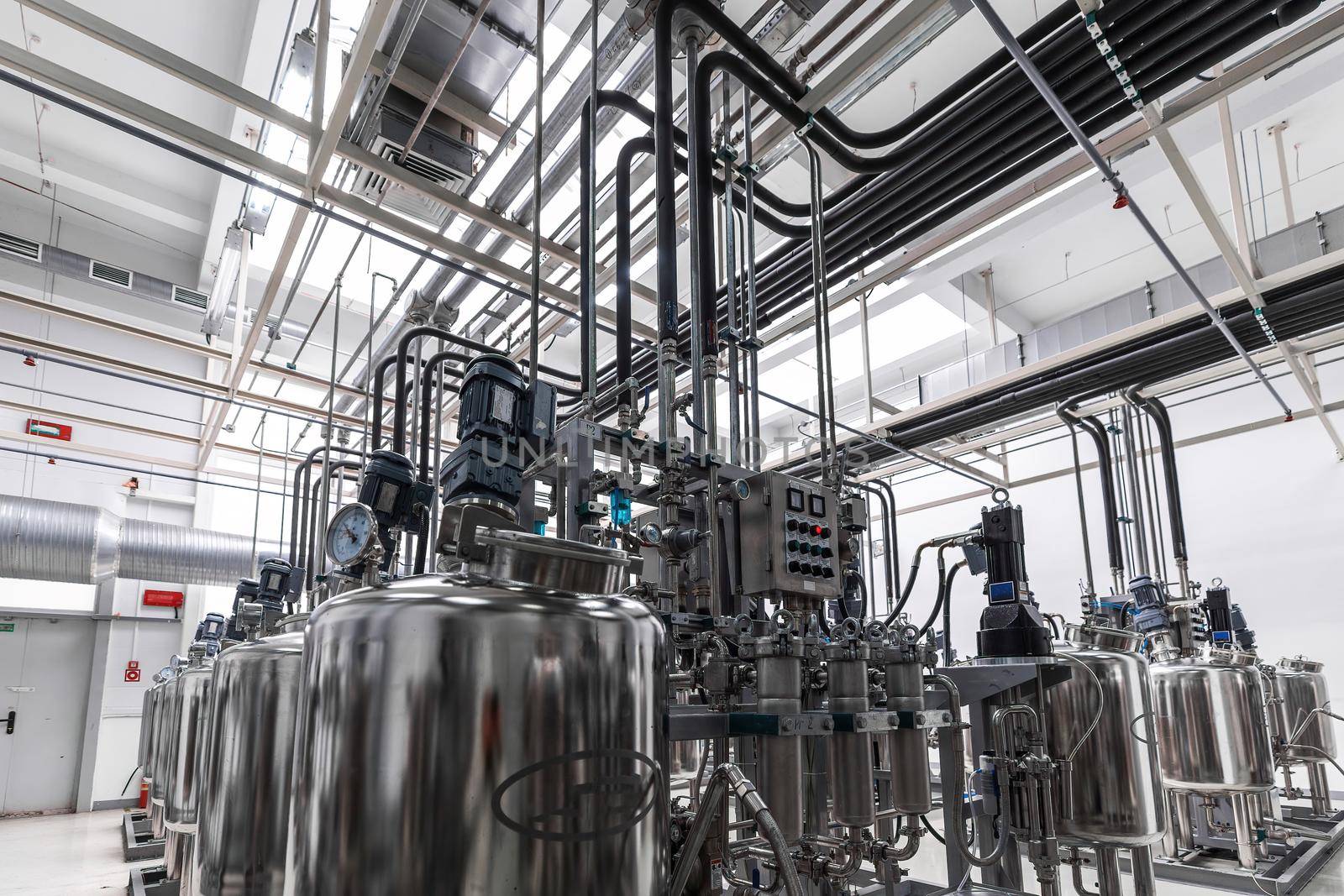Photo of pipes and tanks. Chemistry and medicine production. Pharmaceutical factory. Interior of a high-tech factory by TRMK