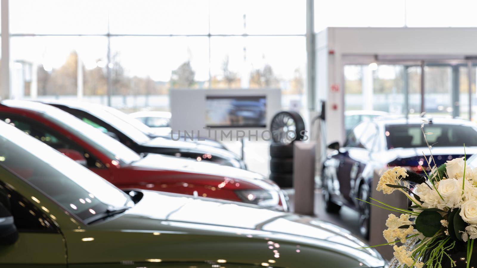 showroom of an official car dealership, photo with depth of field focus in the foreground.
