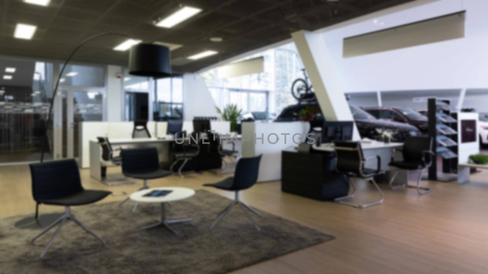 reception of a dealership car showroom of premium cars, photo with blur, modern office interior.