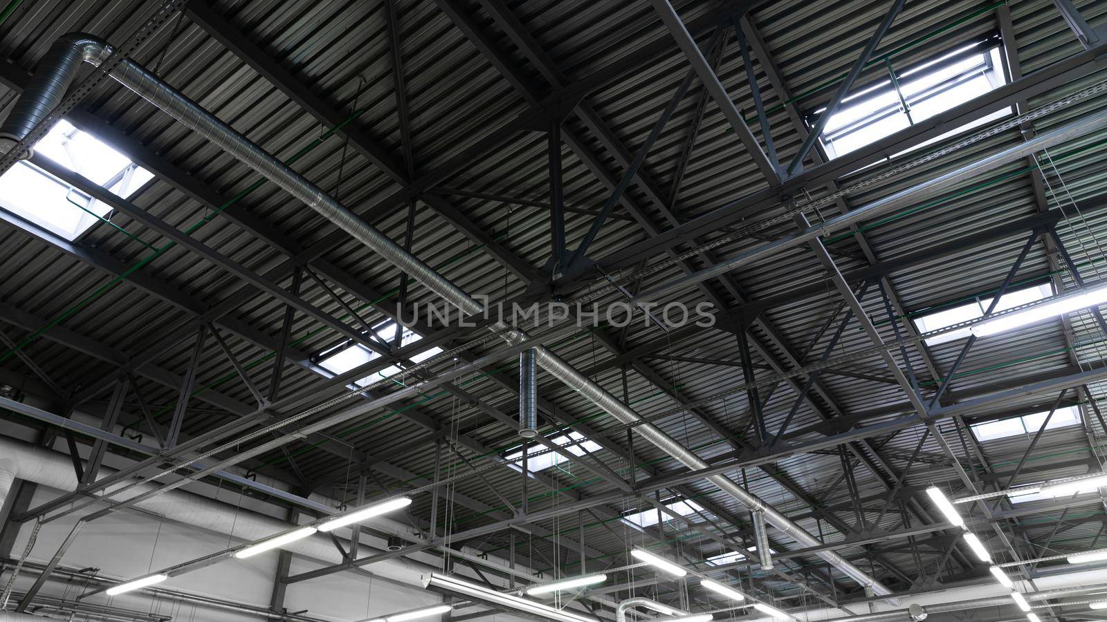 interior of the industrial Hangar with a ventilation system under the roof and glazing in the ceiling.