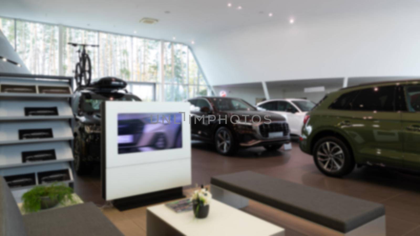 reception of a dealership car showroom of premium cars, photo with blur, modern office interior.